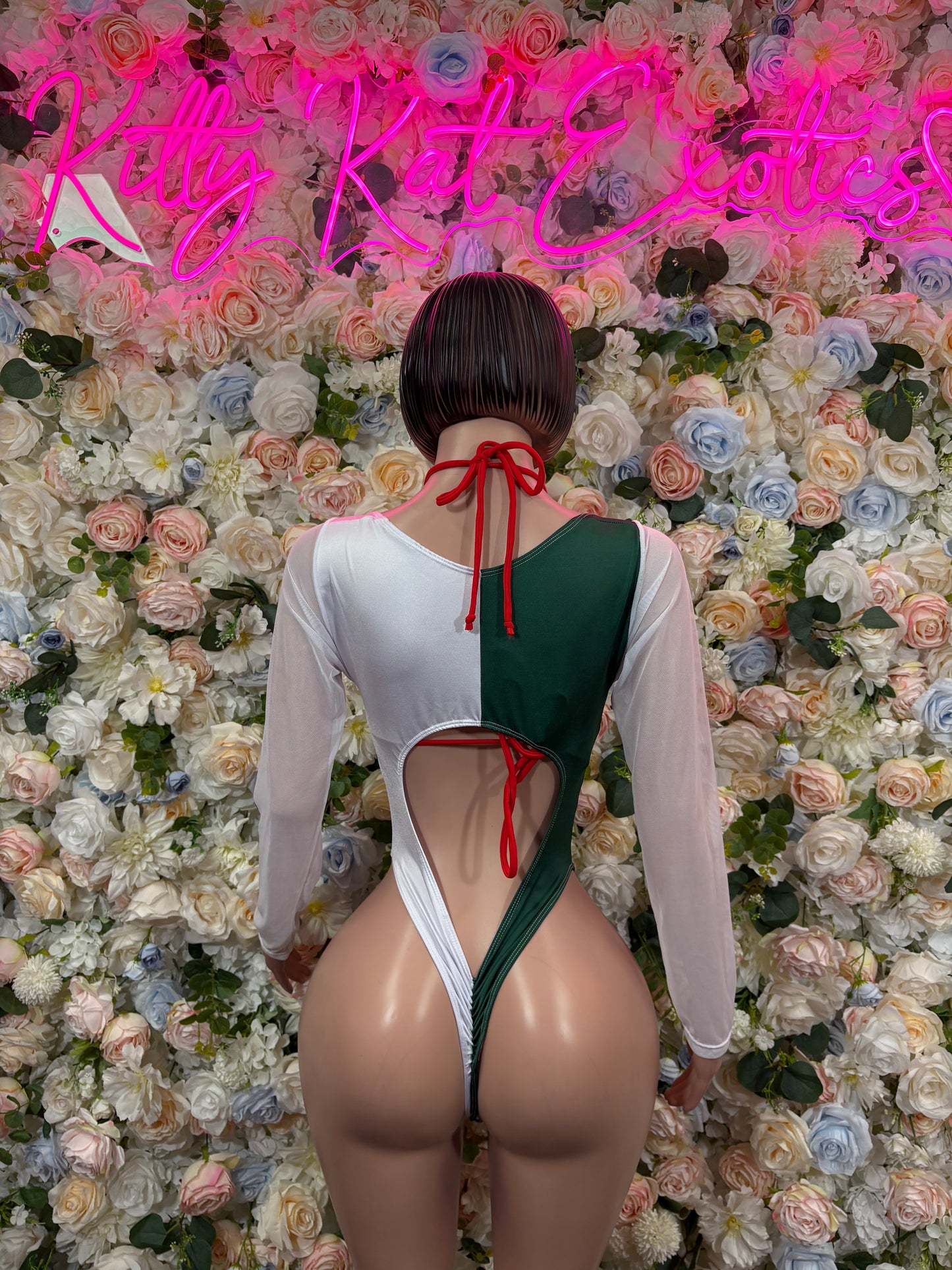 Women’s bikini one-piece bodysuit back view, green panel with red lace-up straps