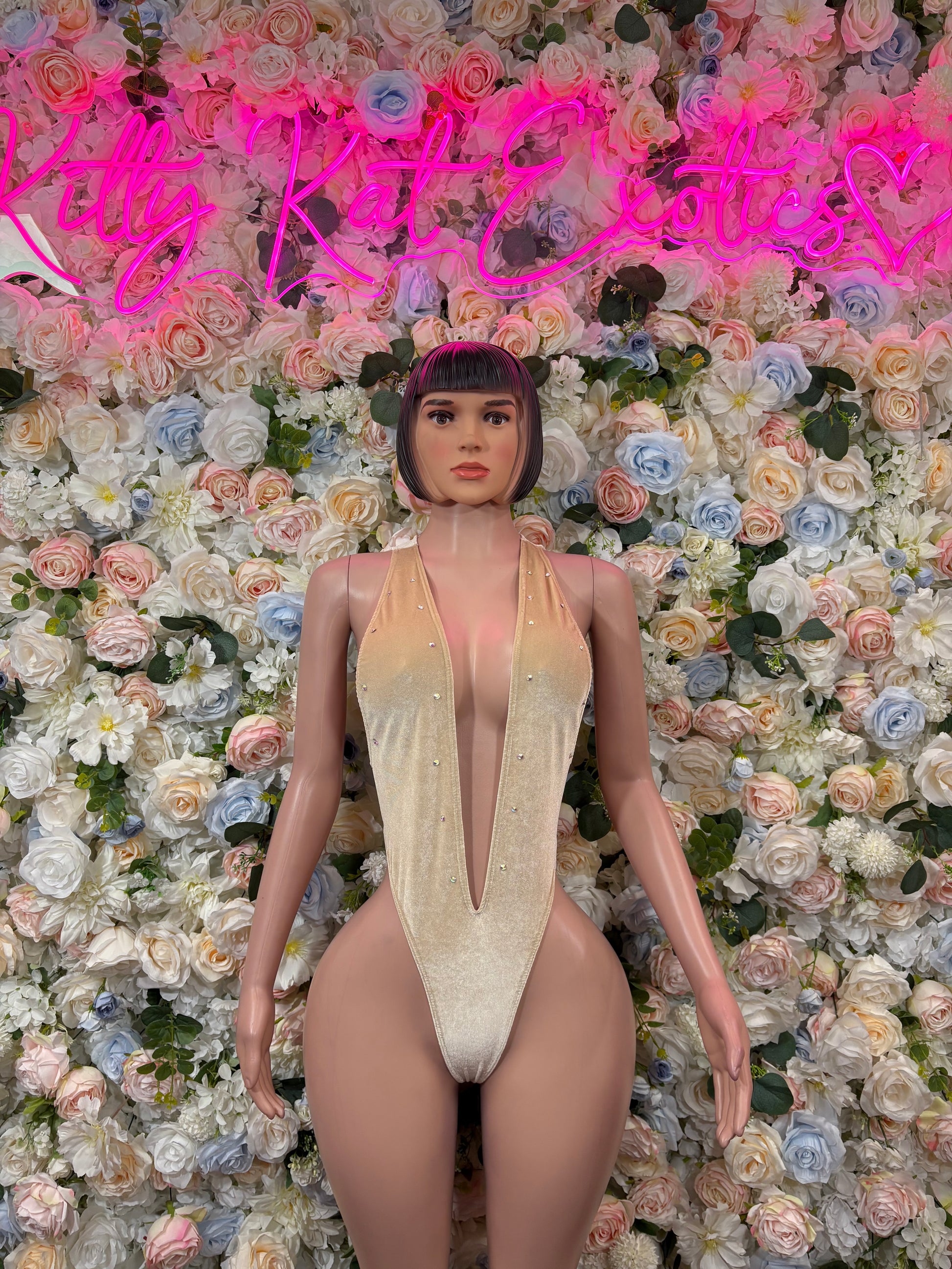 Tan velvet bodysuit with deep V neckline and halter straps, thong bottom.