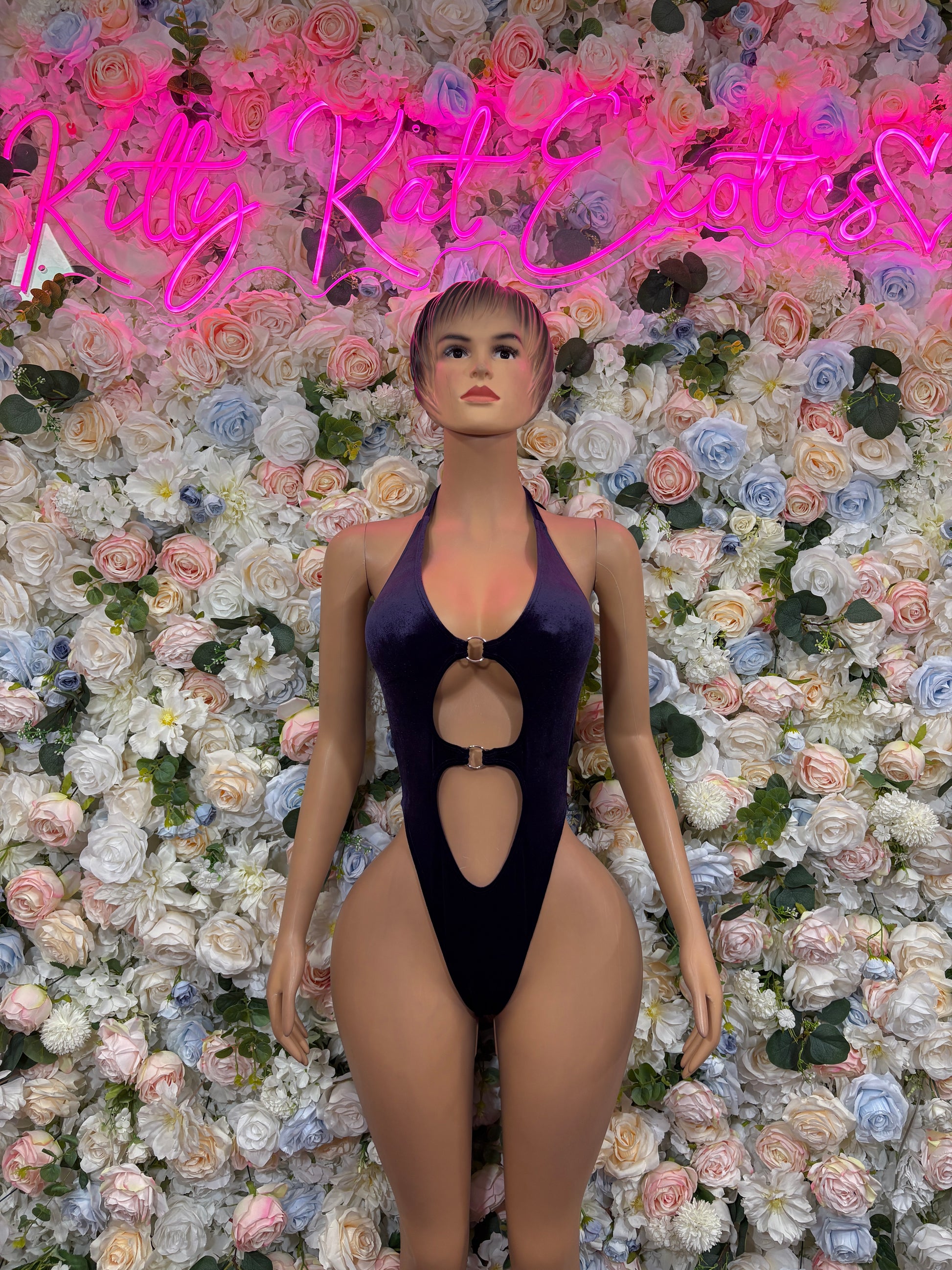 Dark purple velvet one-piece bodysuit with plunging neckline and oval keyhole cutouts
