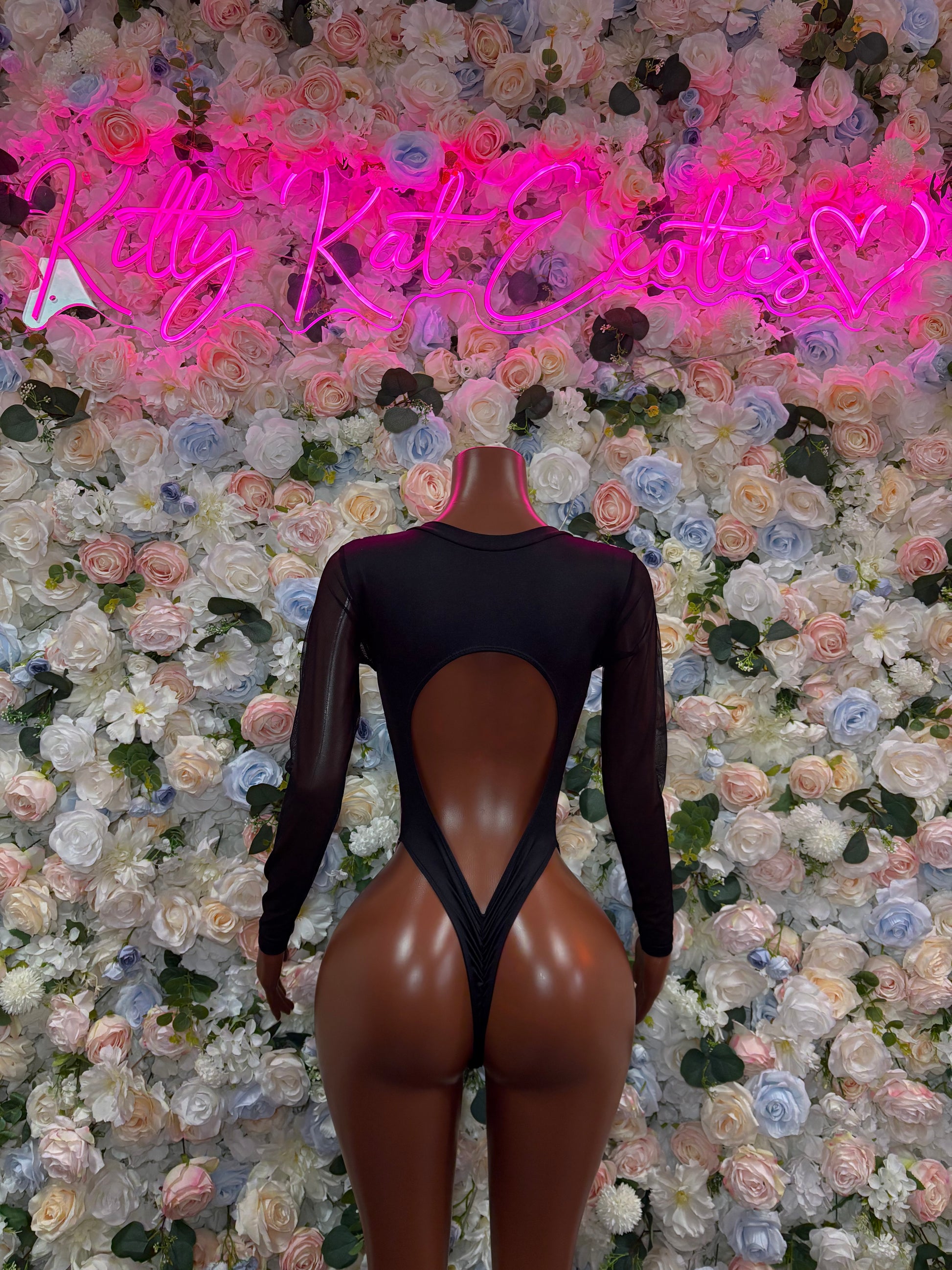 Black long-sleeve bodysuit with neon pink lightning bolt back print and open back