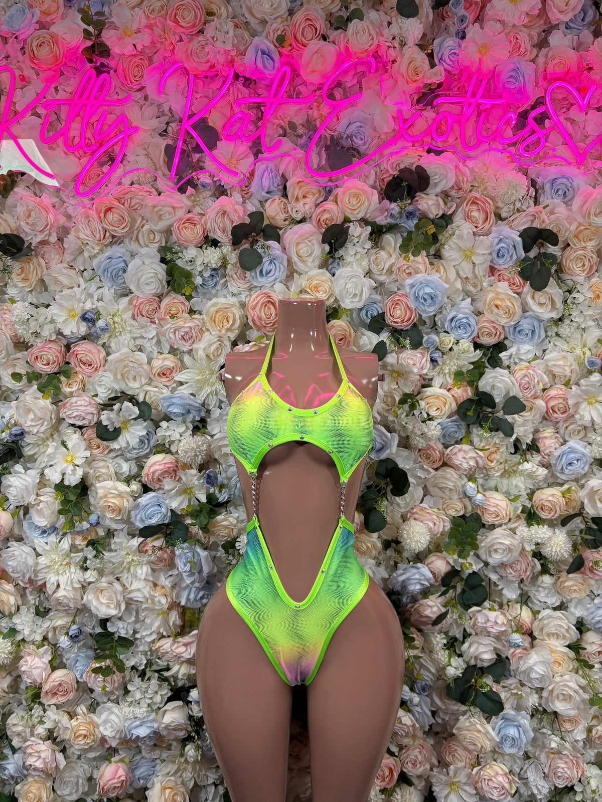 Neon green one-piece rave bodysuit with front cutout and high-cut leg openings