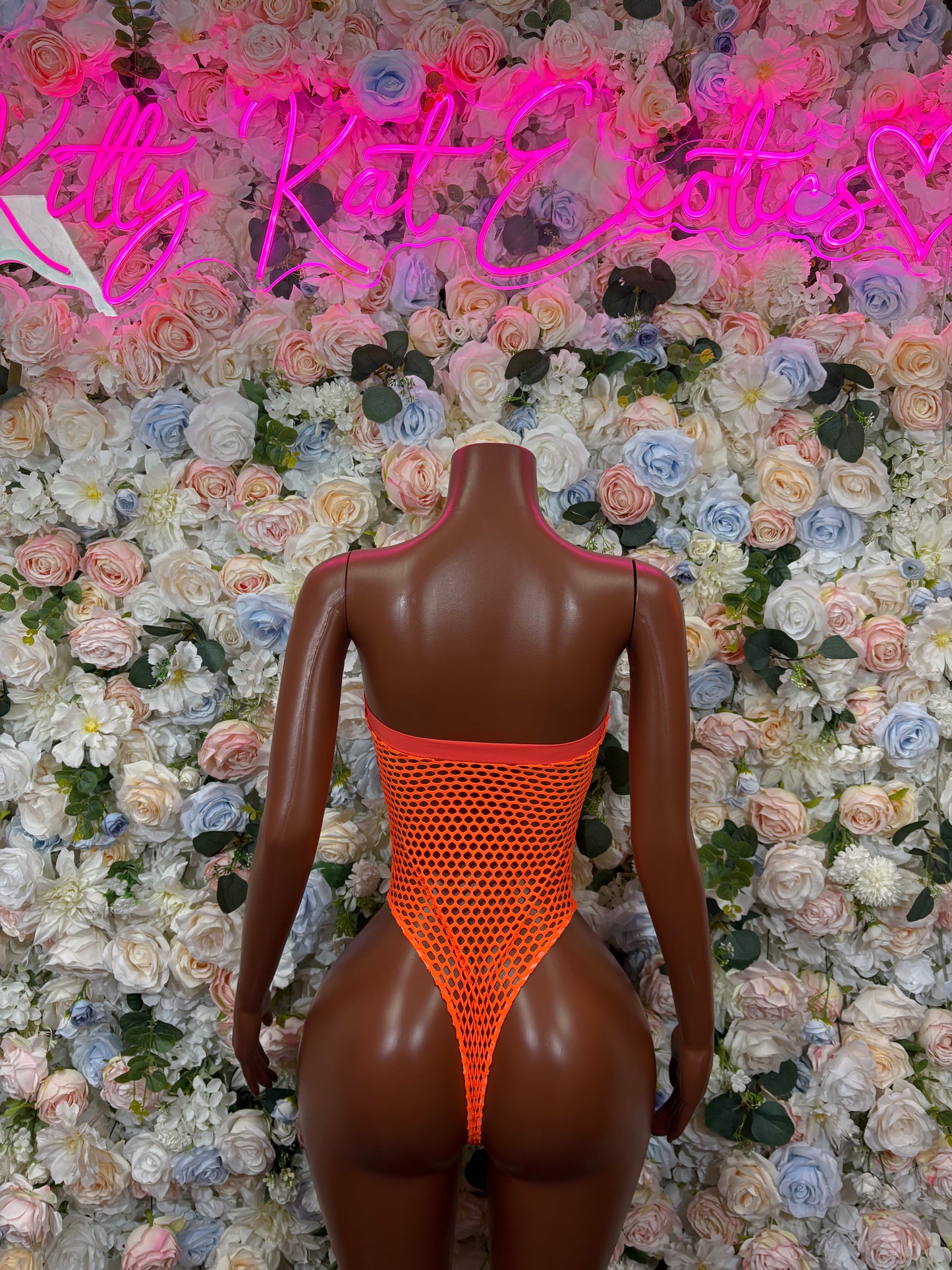 Orange mesh one-piece bodysuit with open back and high-cut legs