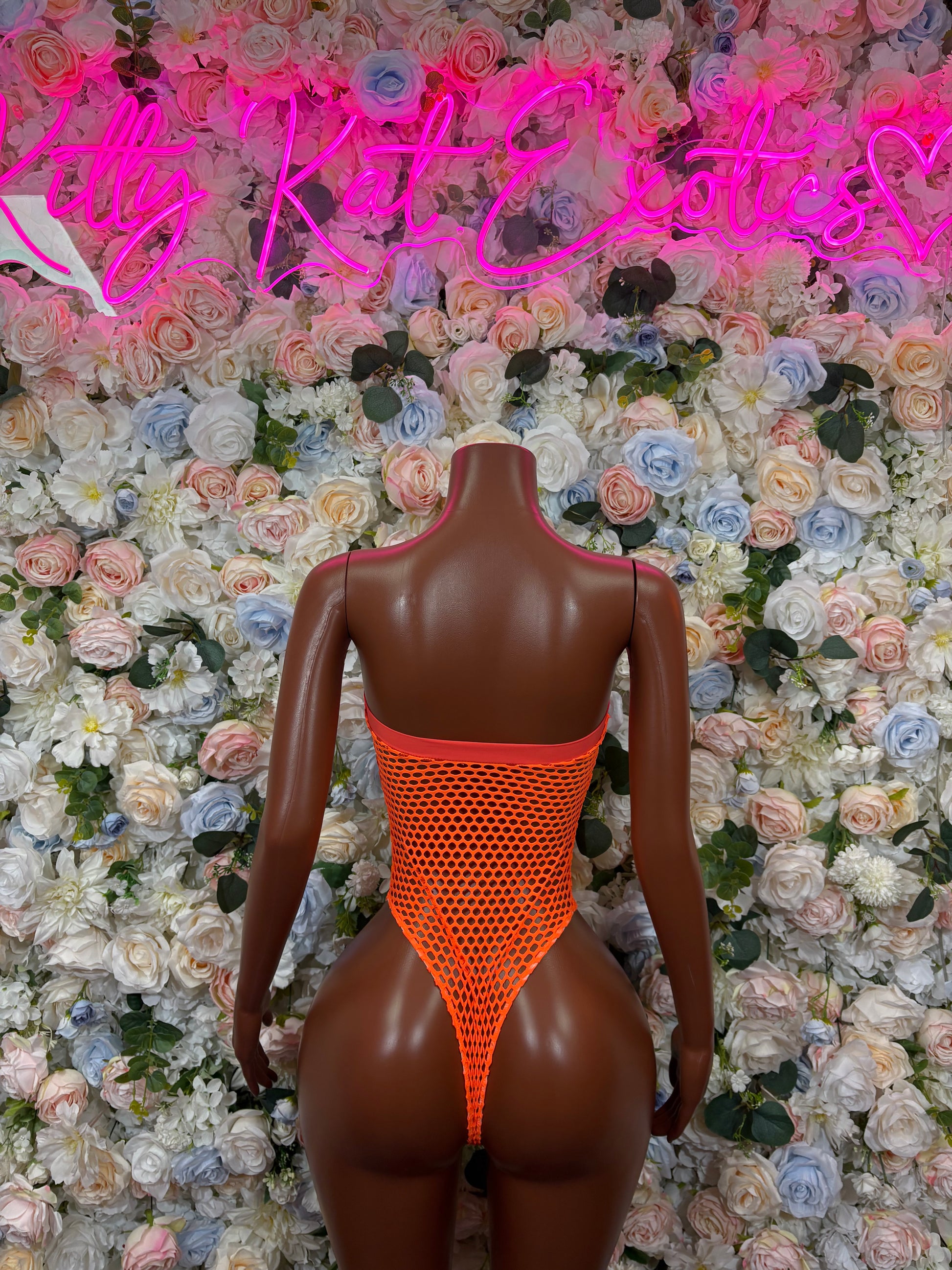 Orange mesh one-piece bodysuit with open back and high-cut legs
