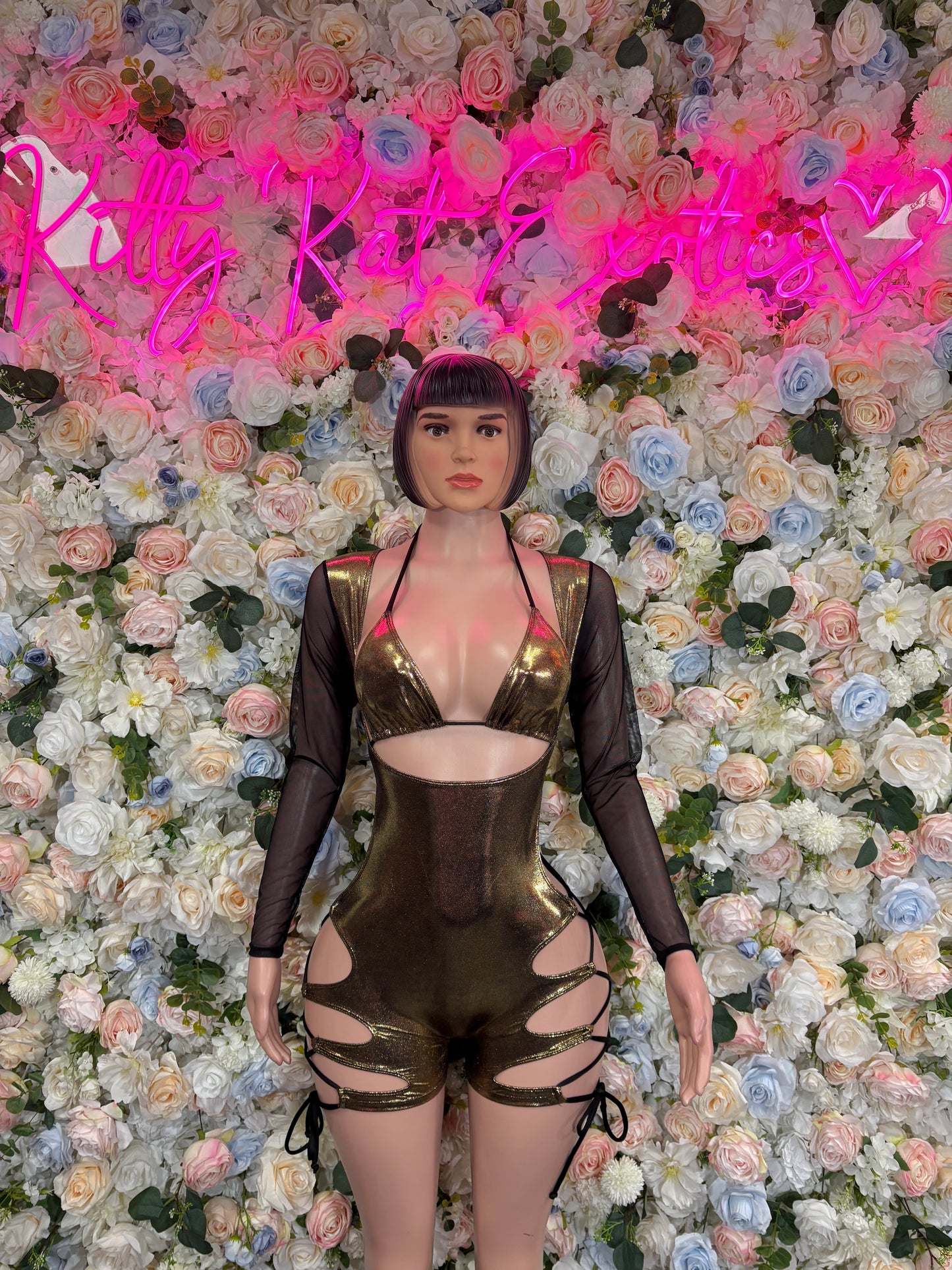Gold metallic bodysuit with long sleeves, deep V neckline, cutout straps and garter-like laces