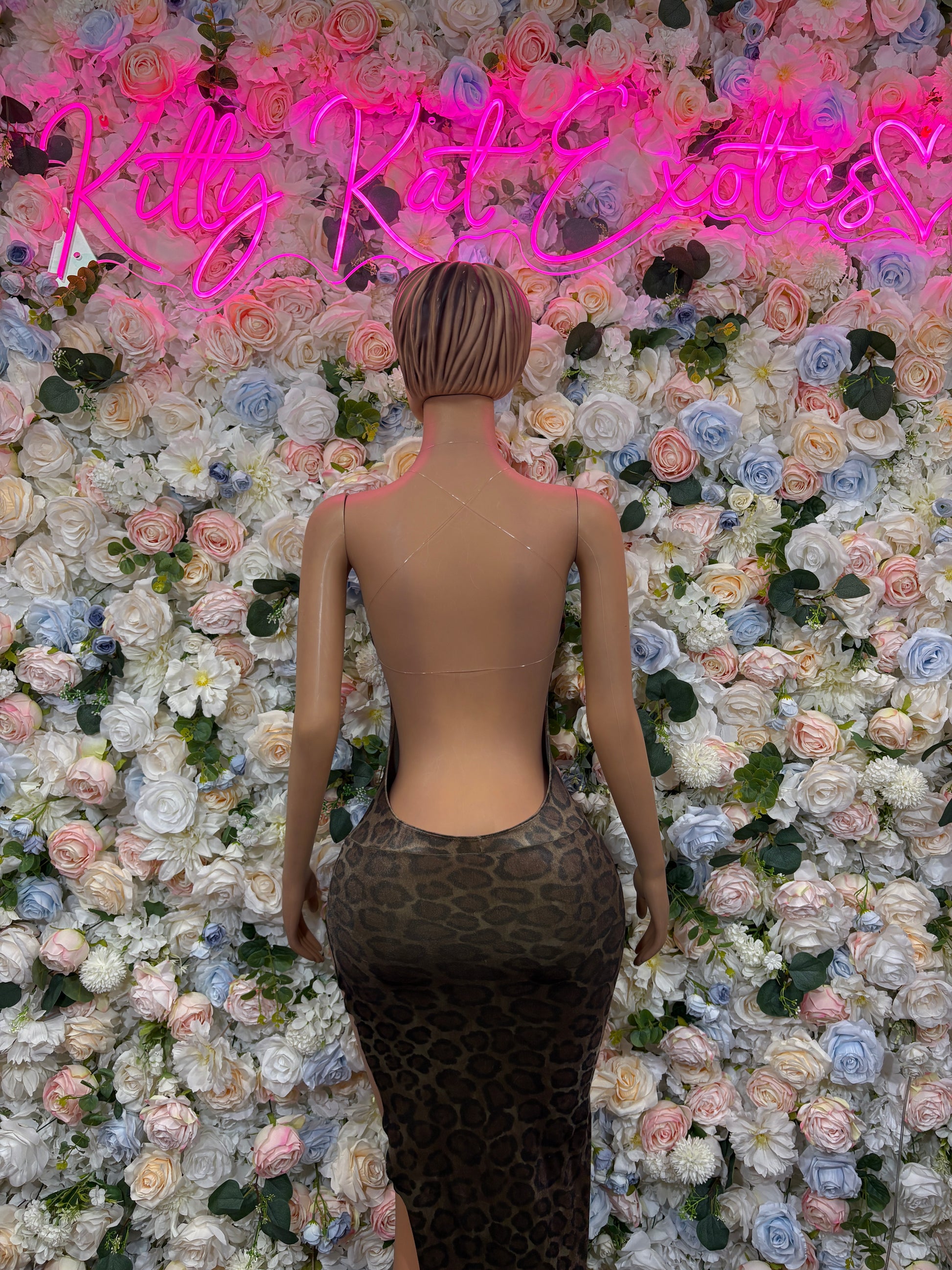 Back view of leopard-print velvet rave gown, sleeveless bodycon on mannequin