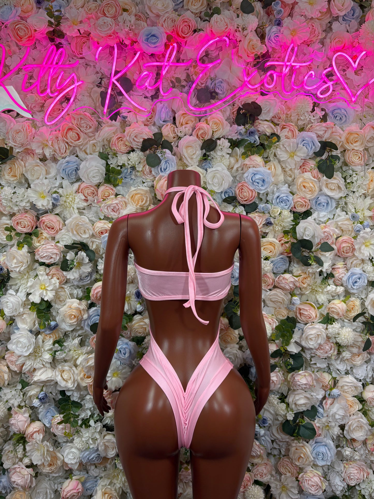 Pink rave bodysuit with halter back tie and thong-style cut