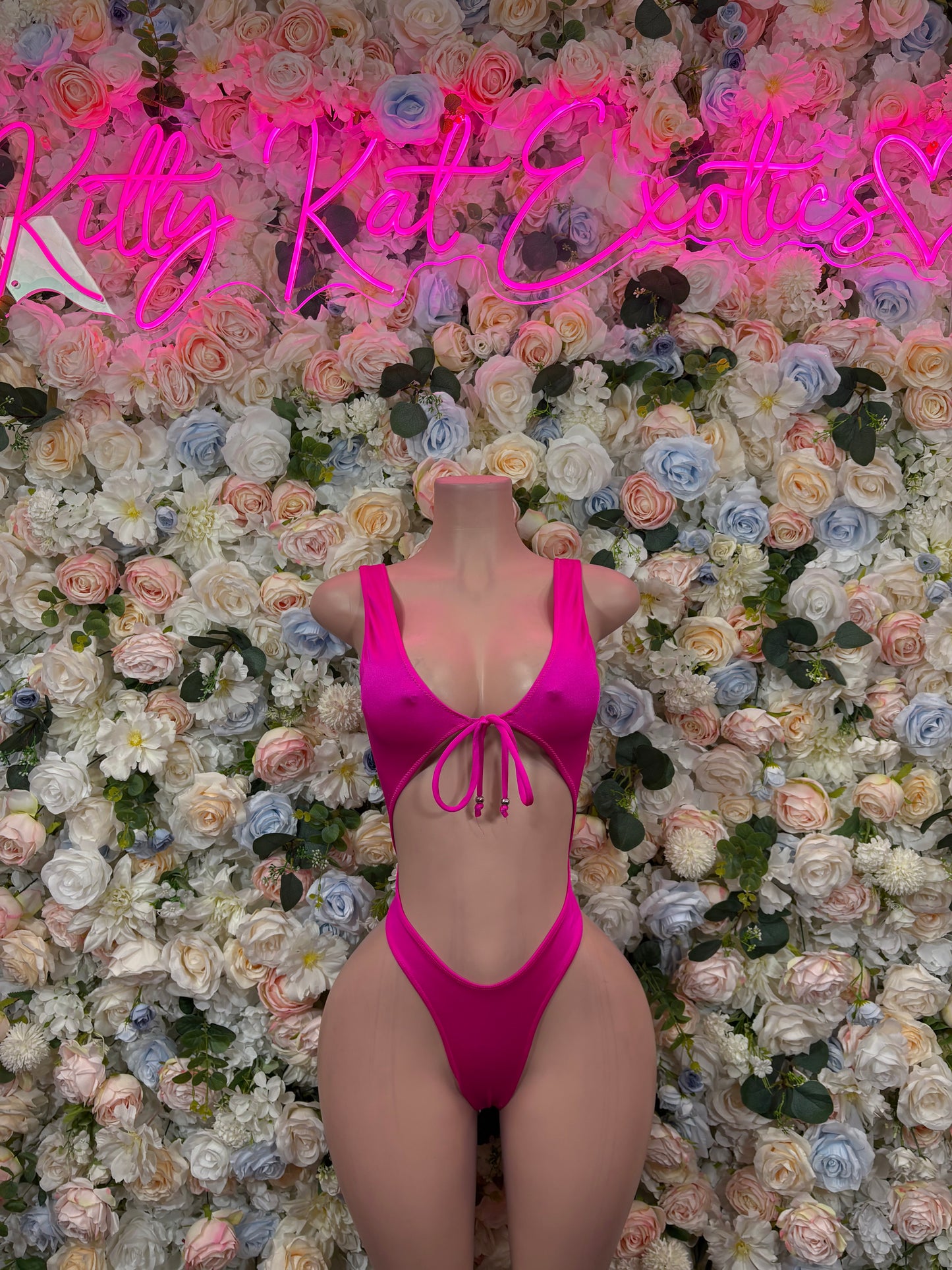 Pink V-neck bodysuit with tie-front and back cutout