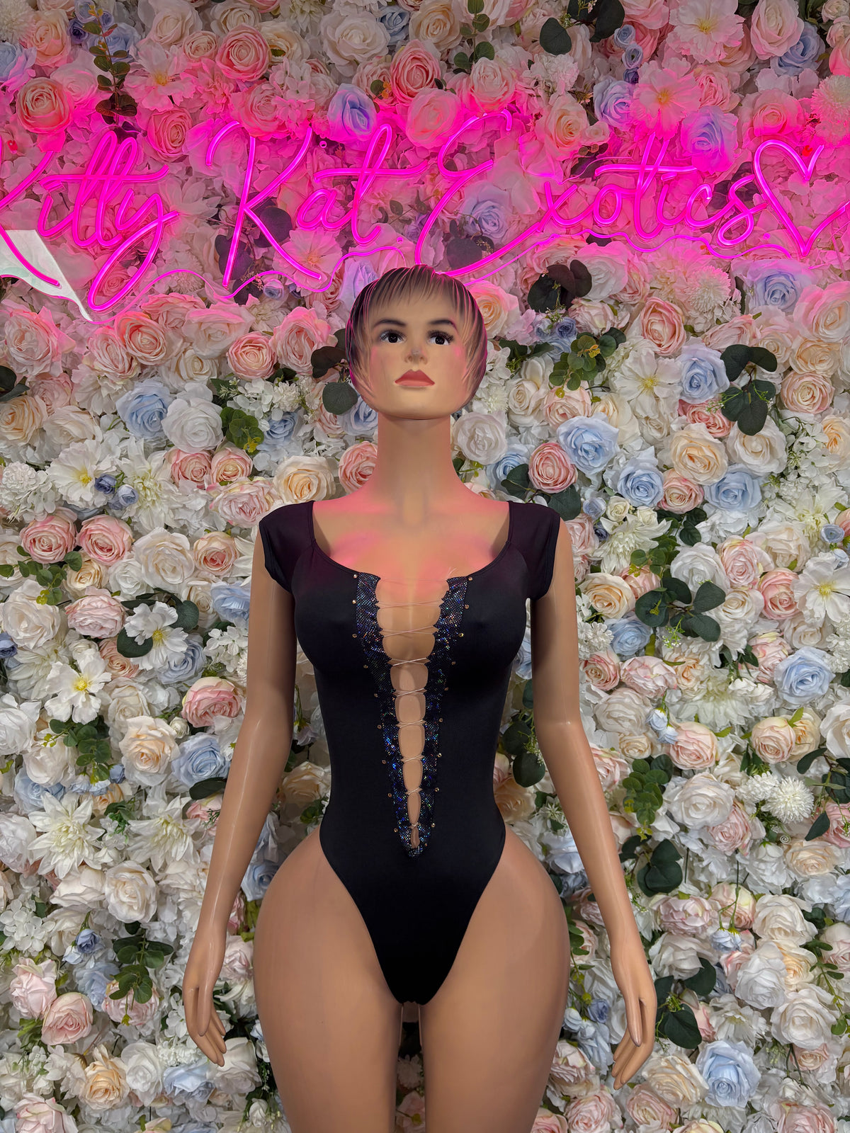 Black sleeveless bodysuit with lace-up front and high-cut legs