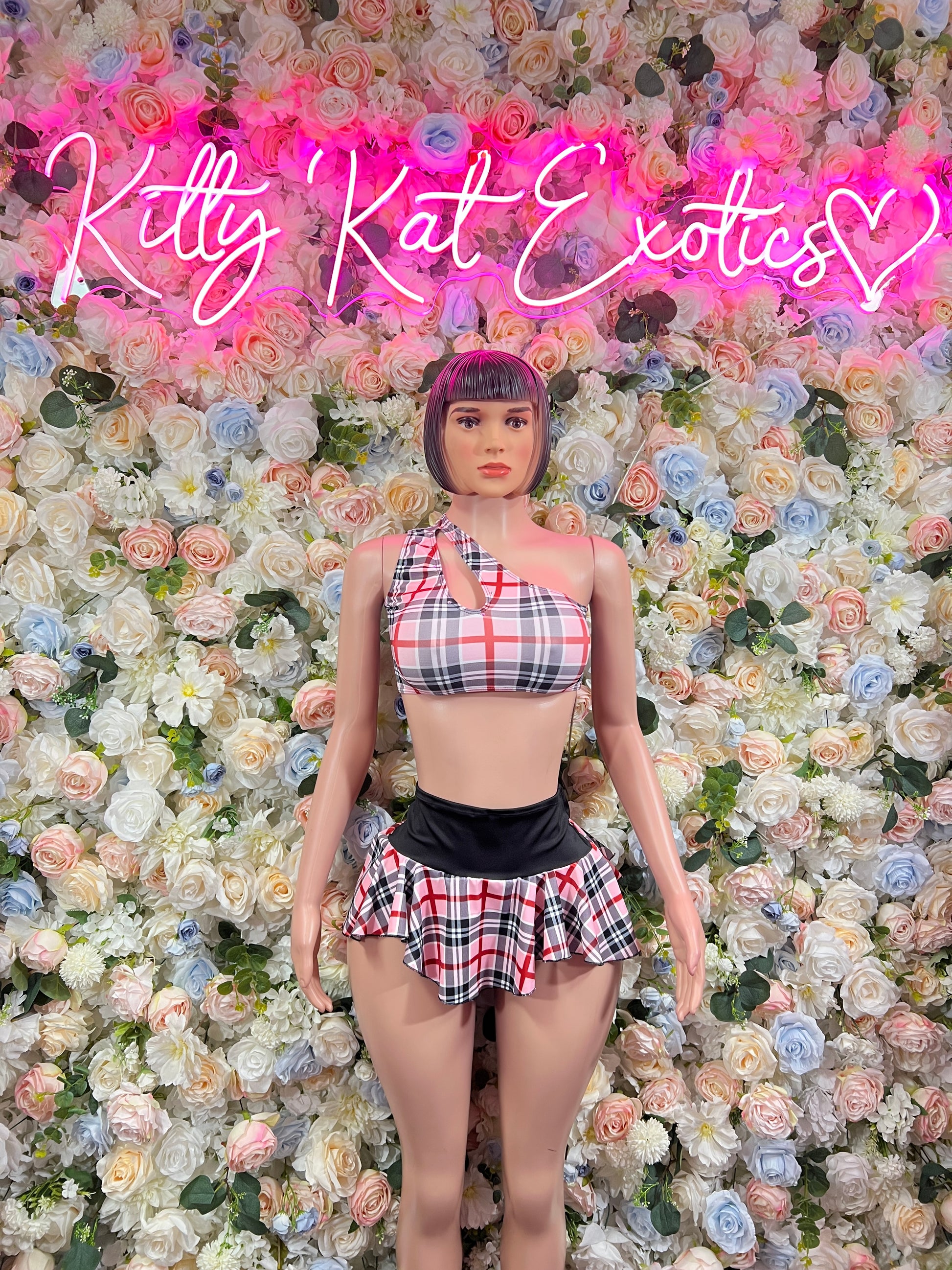 Two-piece skirt set with pink-red plaid crop top and pleated mini skirt, black waistband