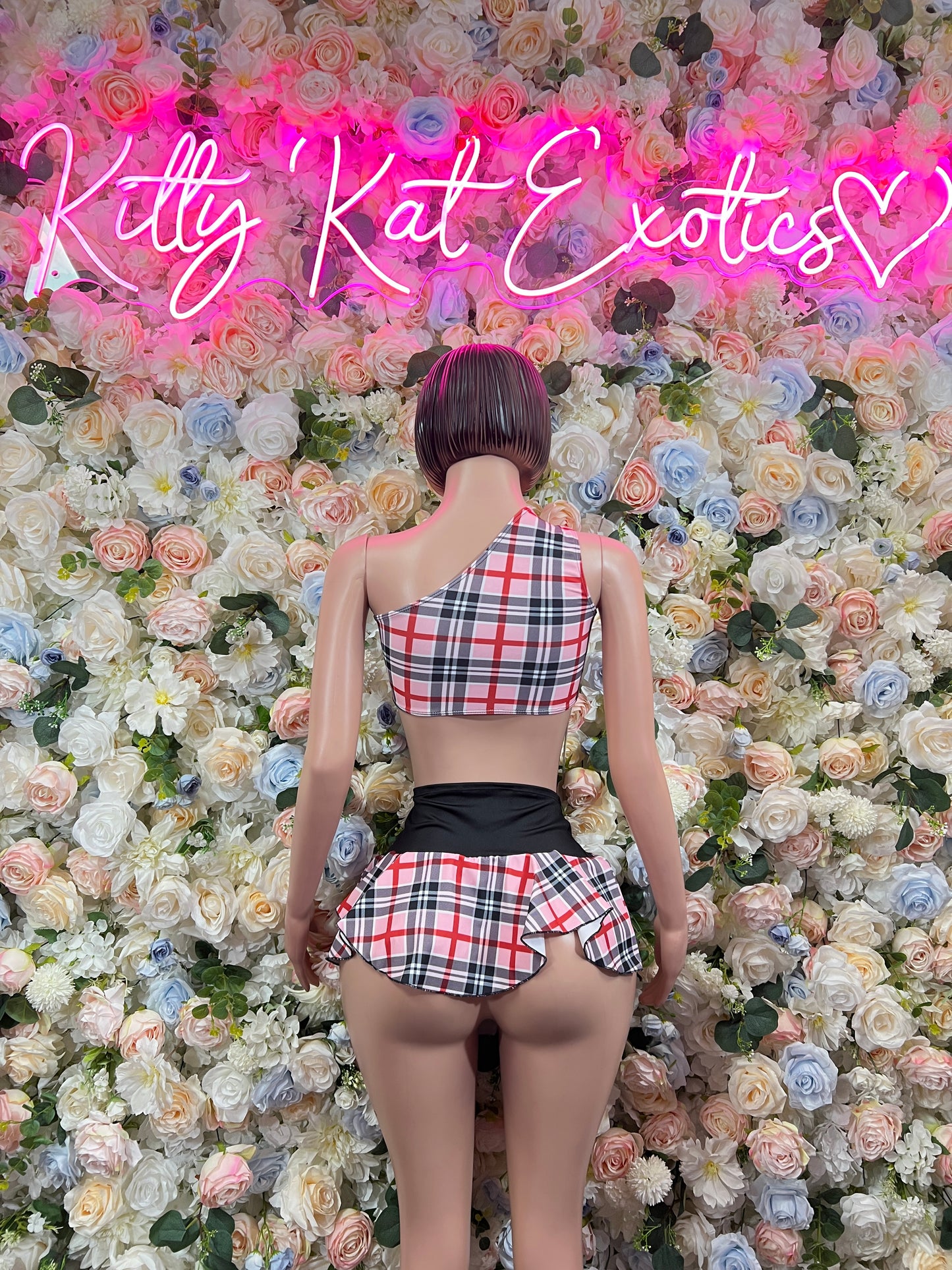Two-piece skirt set, back view: pink-red plaid halter crop top and pleated mini skirt, black trim