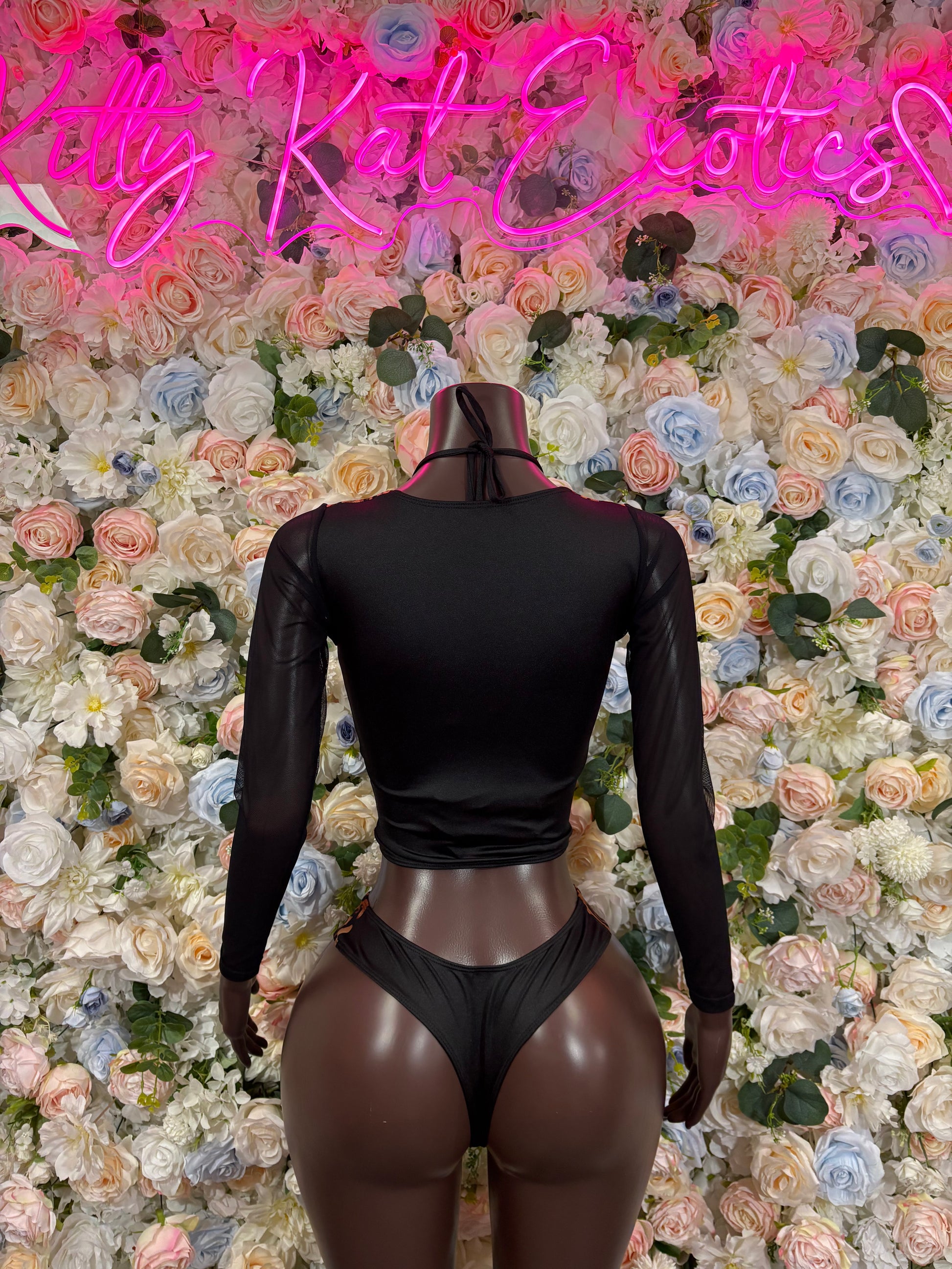 Leopard print bodysuit with black mesh long sleeves, open back and thong bottom