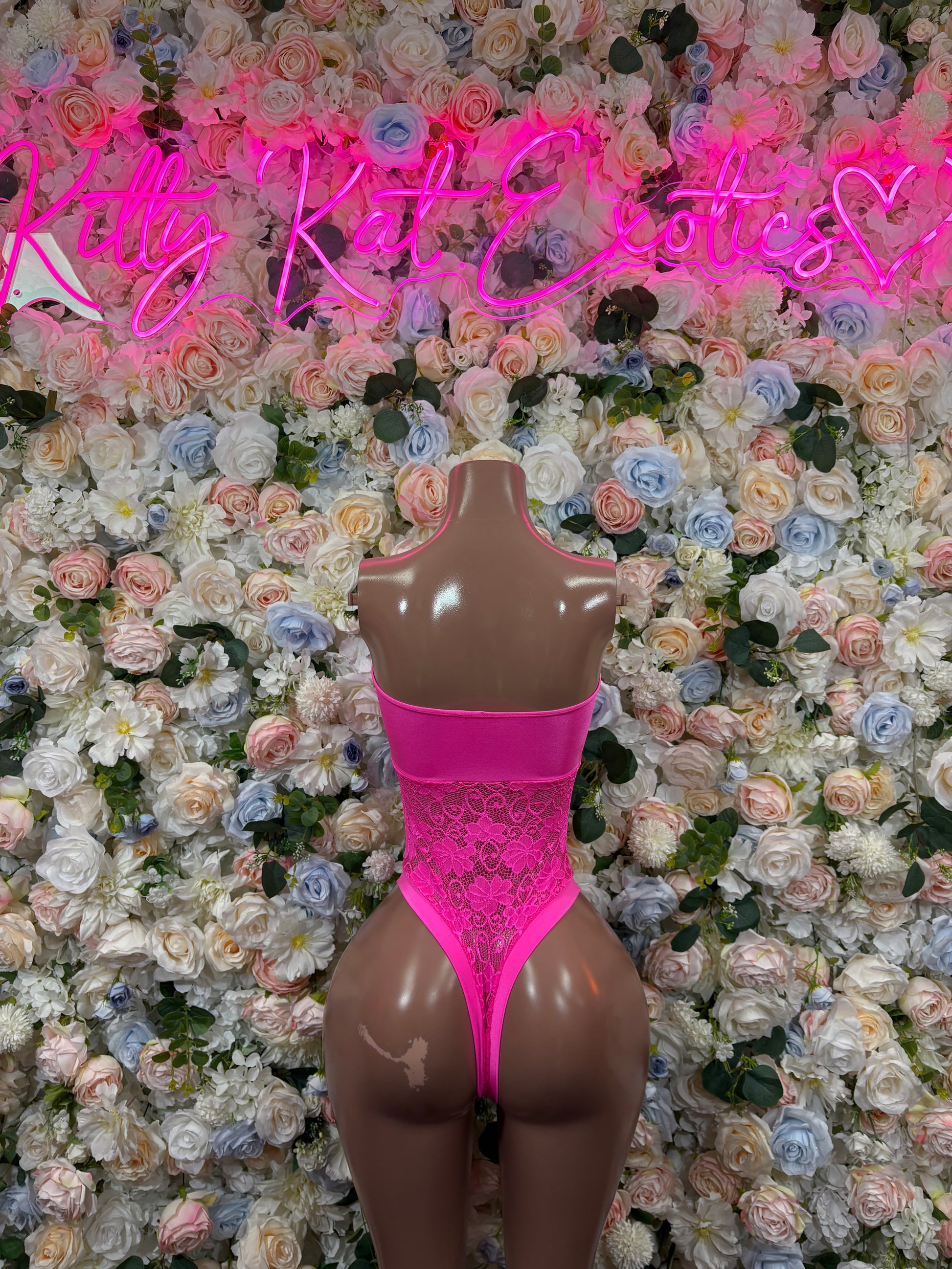 Pink sheer lace bodysuit with high-cut back and strap neckline