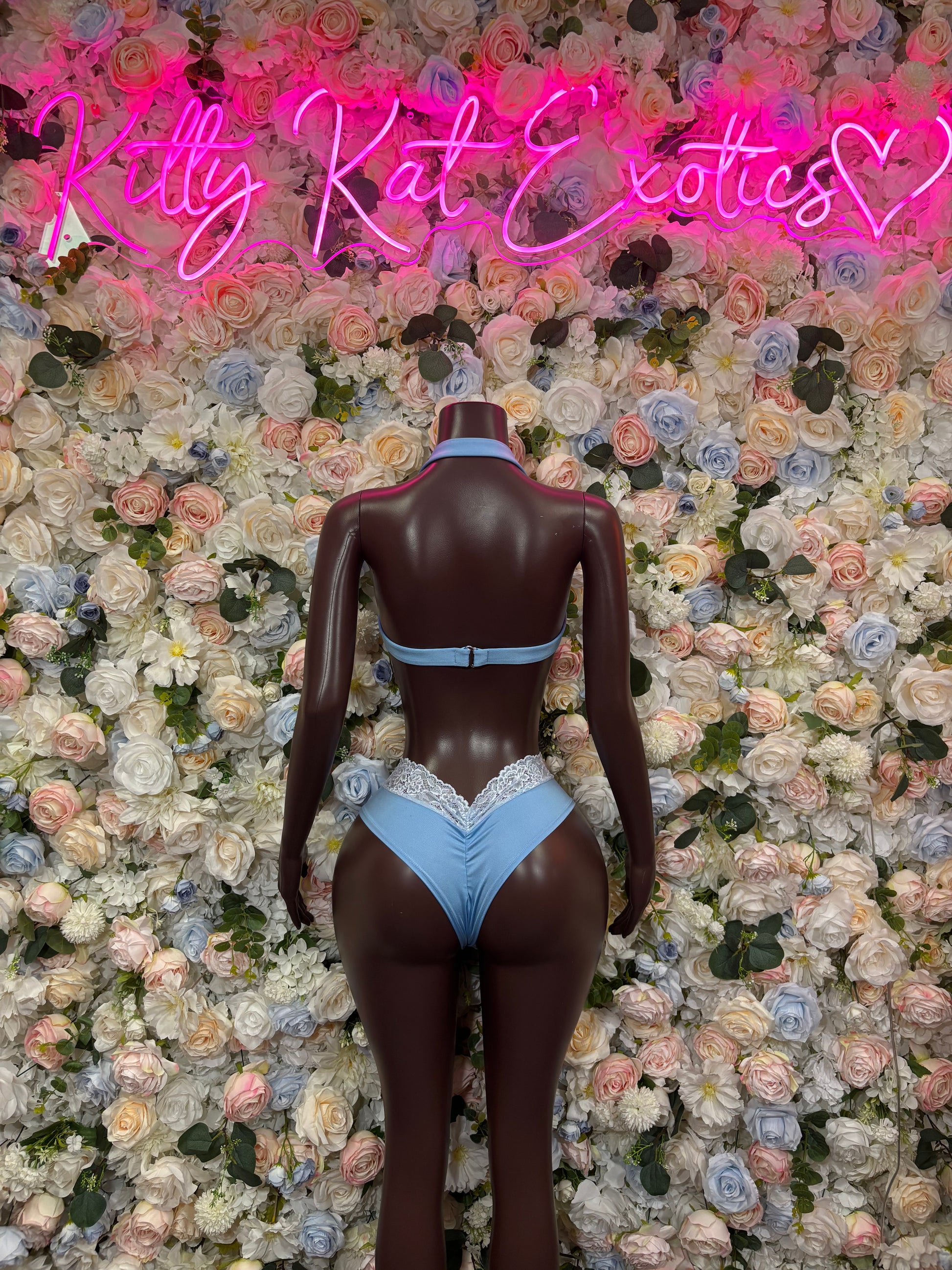 Light blue lace two-piece rave outfit on mannequin, strappy back and briefs