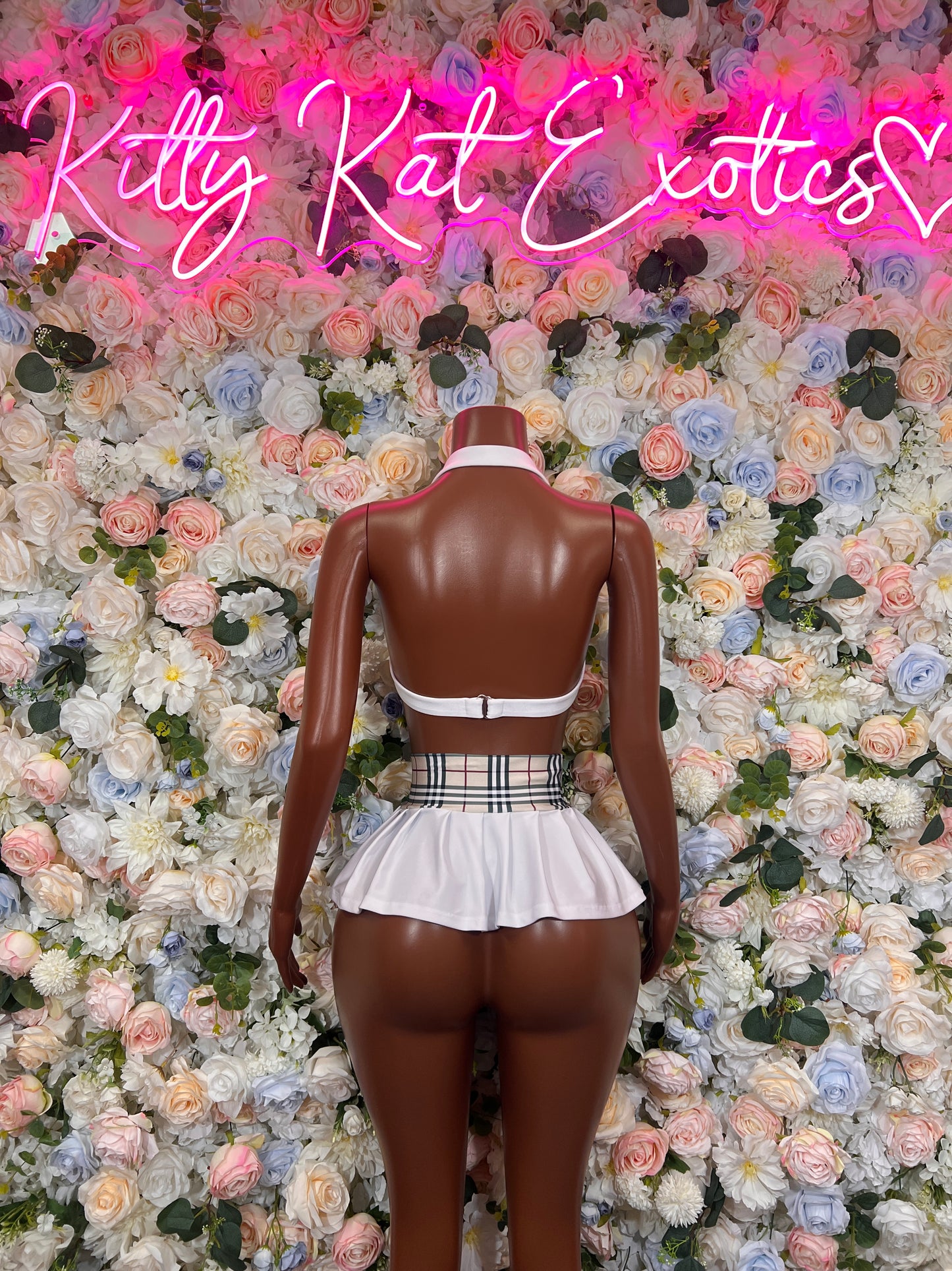 White pleated skirt set with halter bra and striped waistband, back view