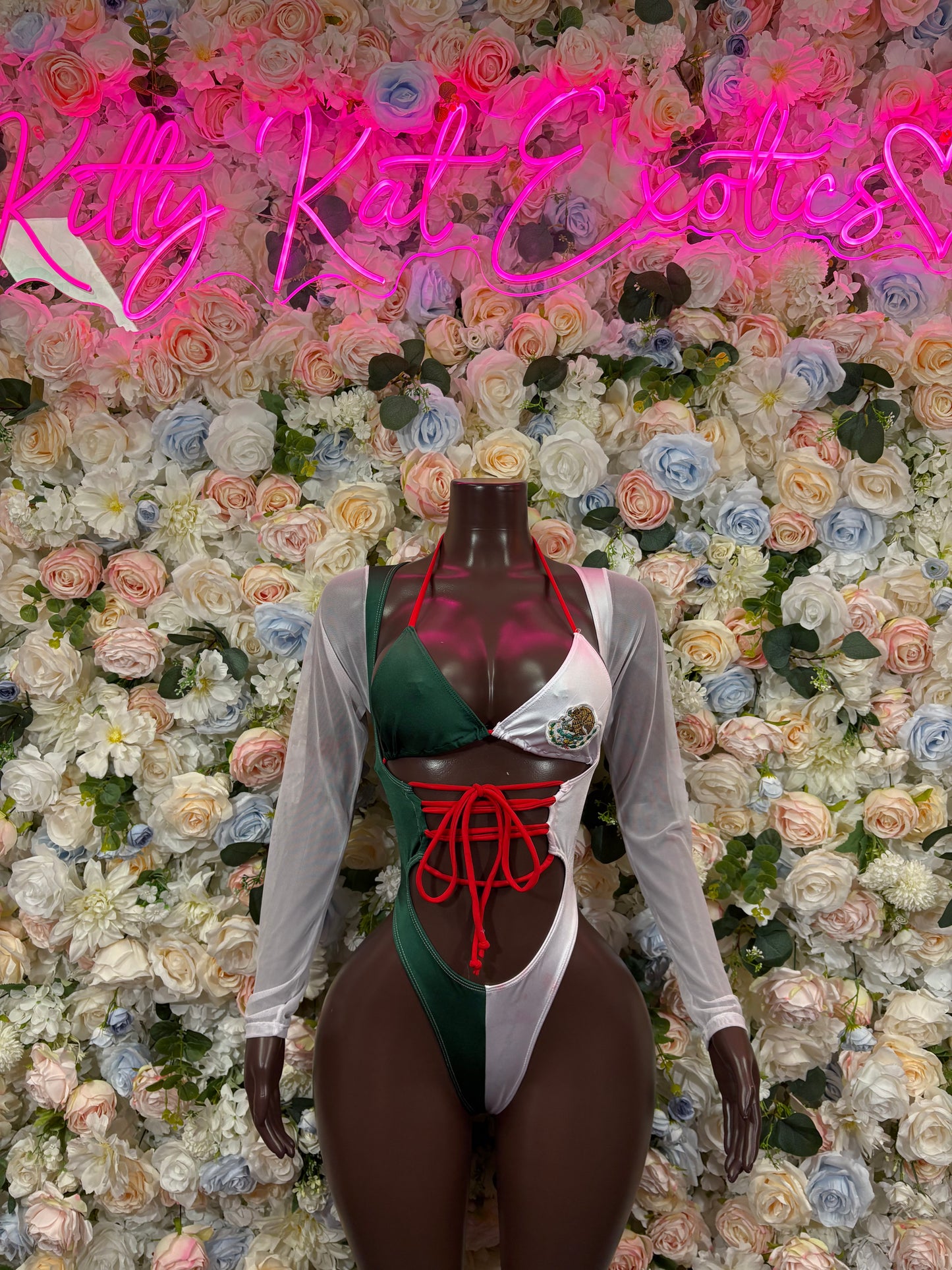 Green, white, and red tie-dye bodysuit with crisscross lace-up front and sheer sleeves