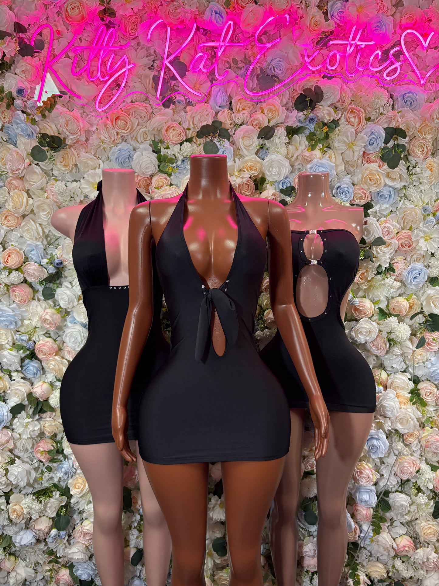 Women’s black mini club dress with deep V neckline and cutout chest detail