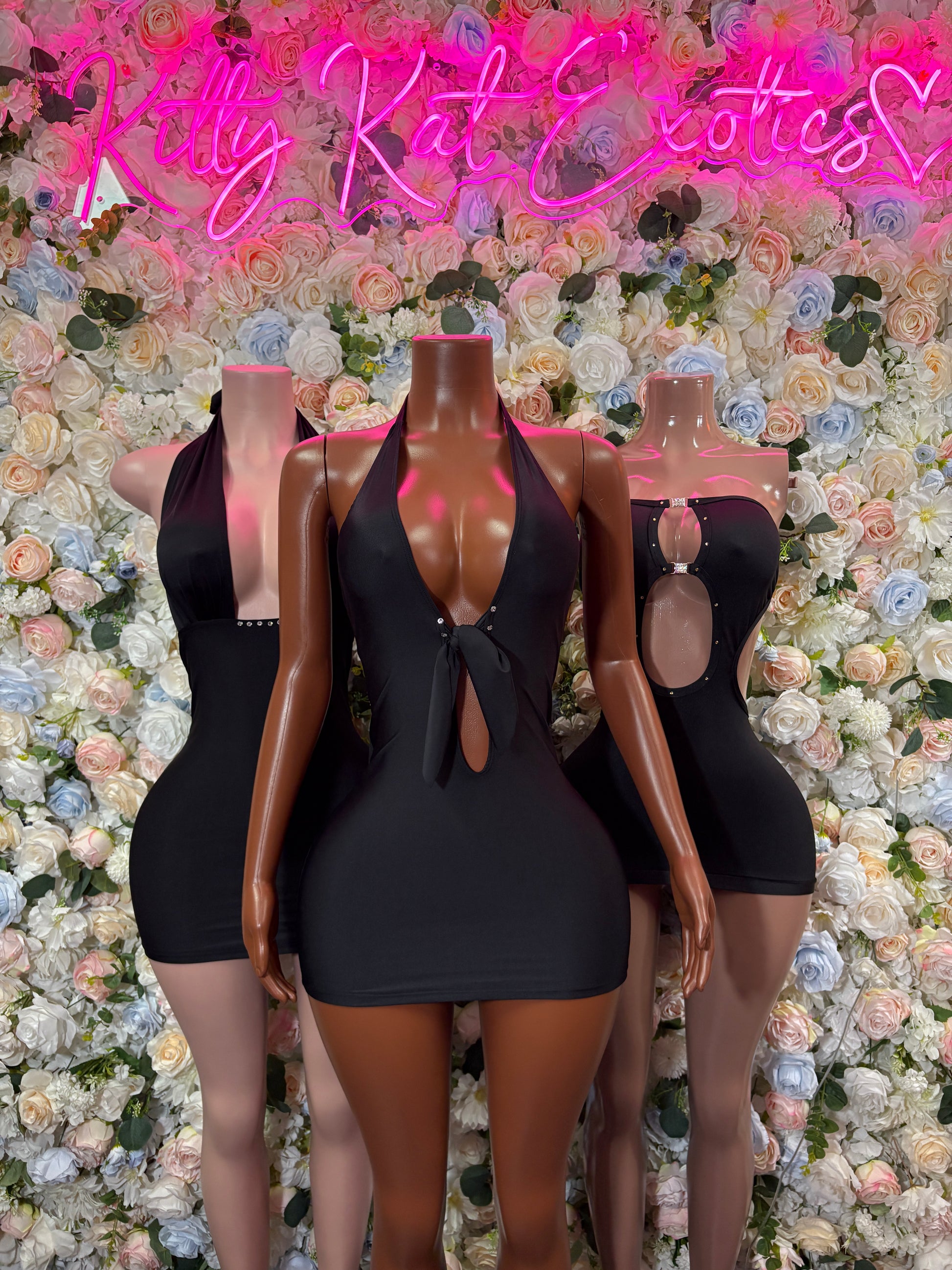 Women’s black mini club dress with deep V neckline and cutout chest detail