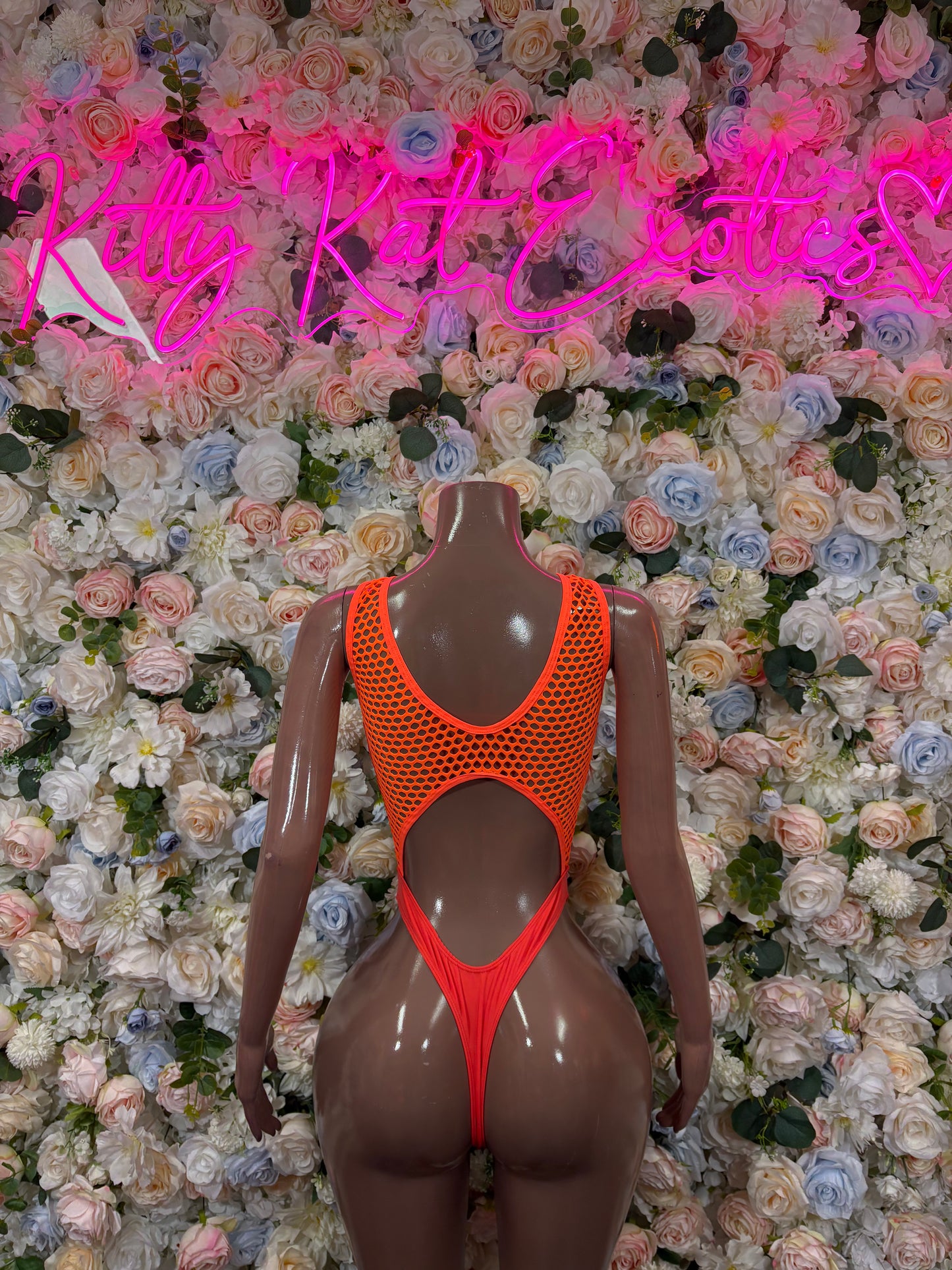 Orange fishnet one-piece bodysuit with cutout back and tie-string detail
