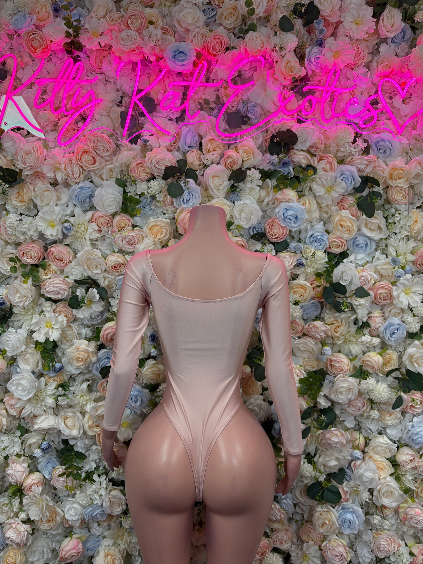 Nude backless one-piece bodysuit with long sleeves and scoop back