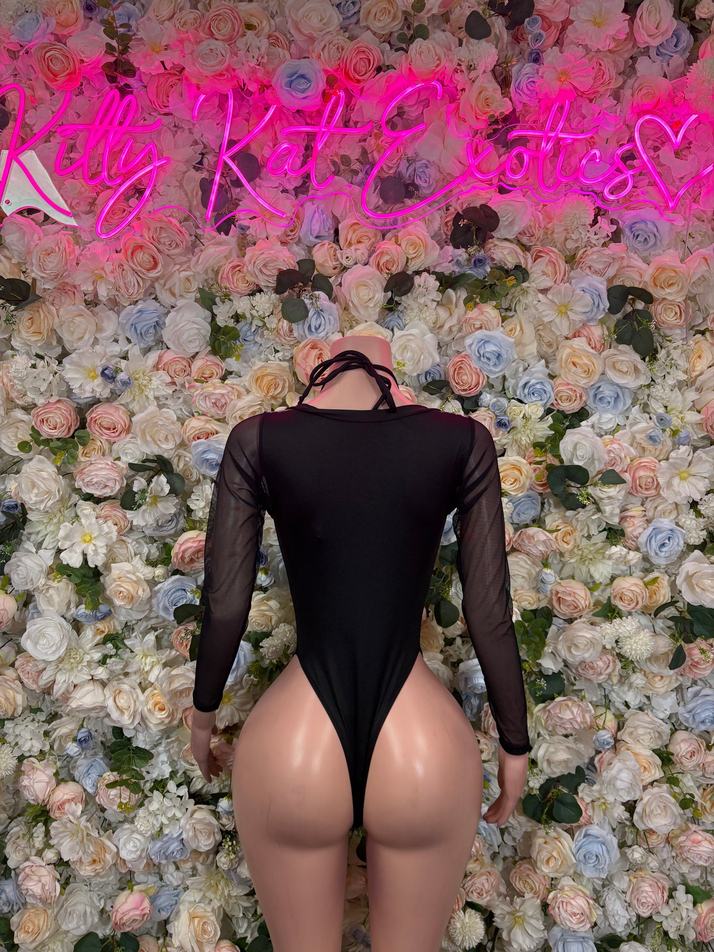 Black backless lace-up bodysuit with long sheer sleeves and thong-style bottom