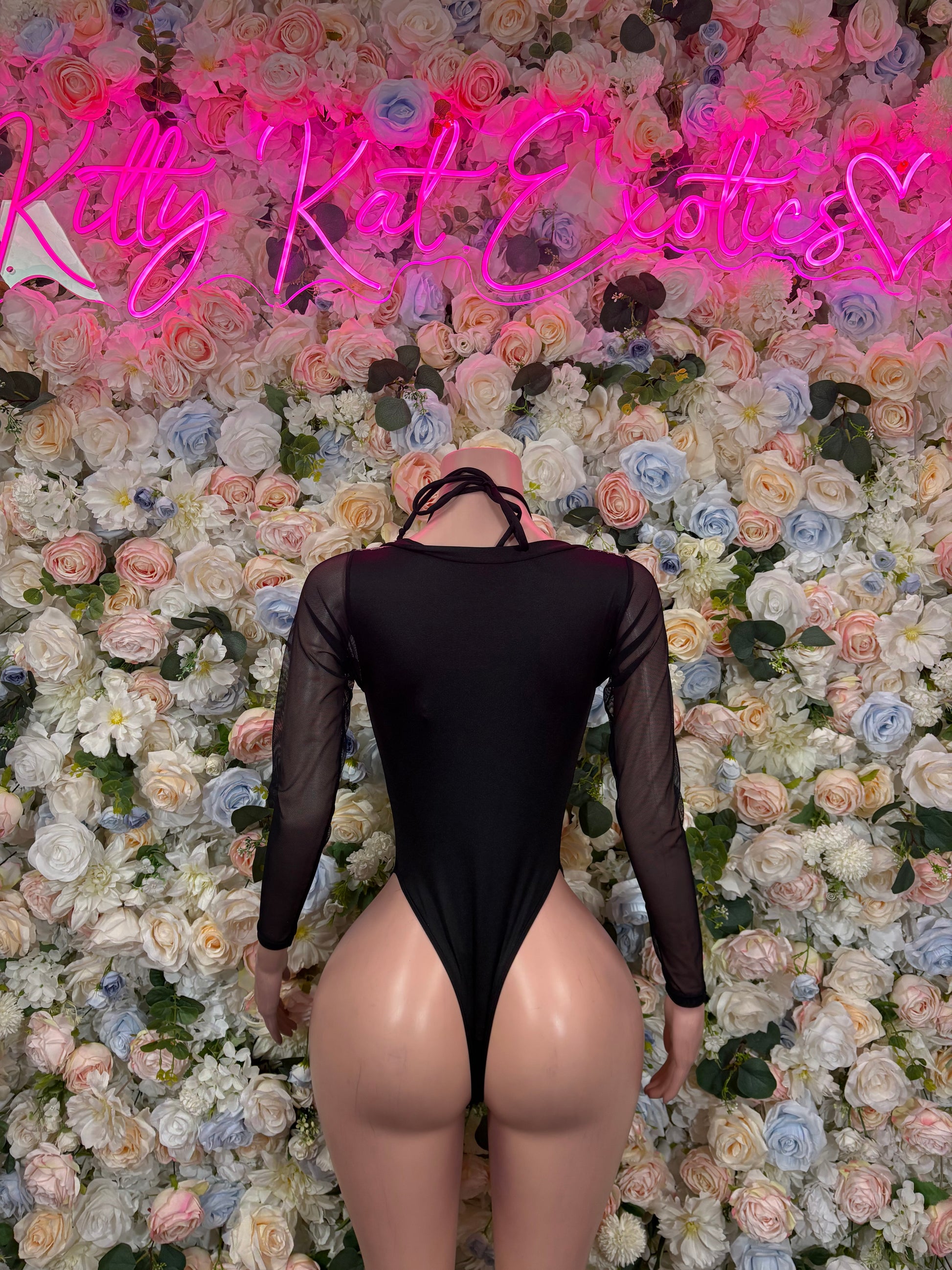 Black backless lace-up bodysuit with long sheer sleeves and thong-style bottom