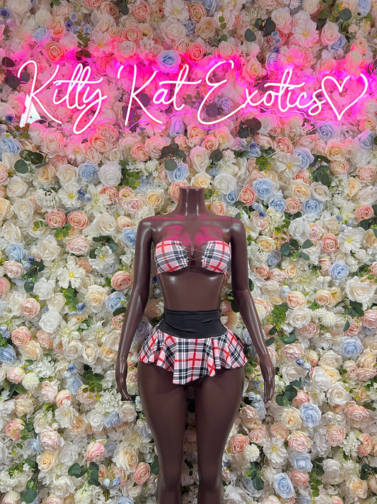 Pink plaid two-piece skirt set with plaid top and black waist belt on mannequin