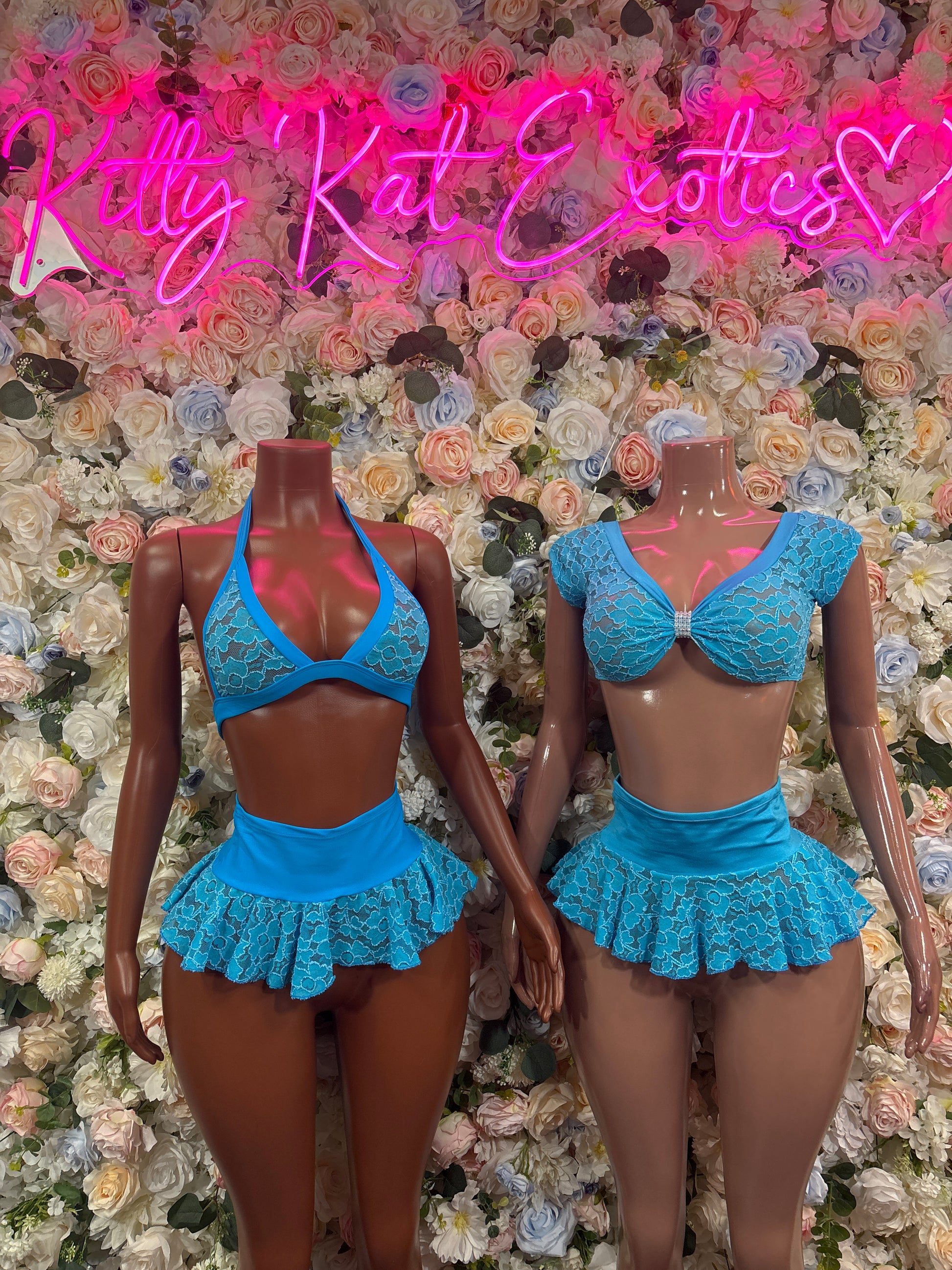 Blue lace mini skirt set on two mannequins, scoop-neck peplum top and mini skirt