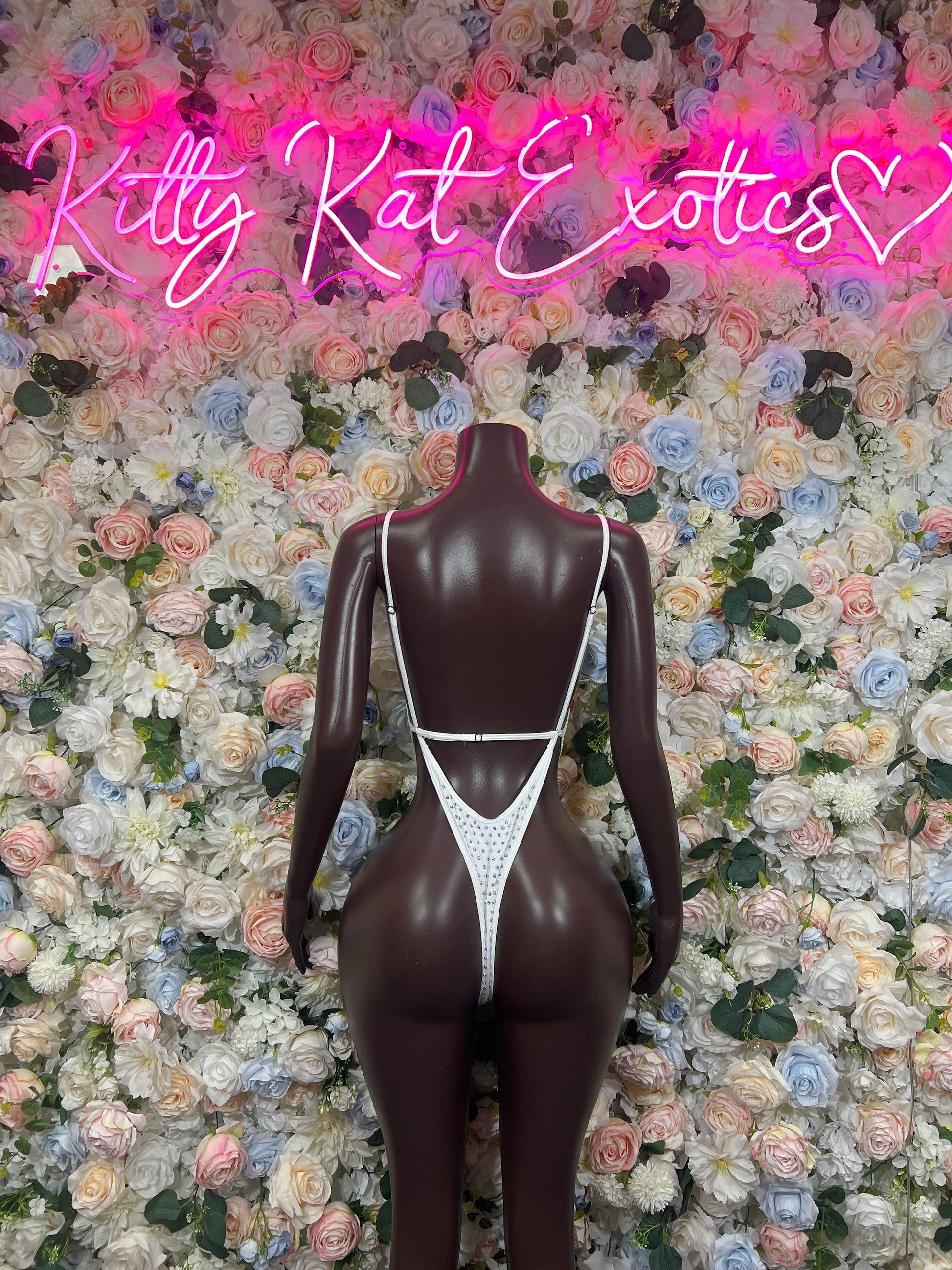 White rhinestone one-piece bodysuit on mannequin, V-neck and thin shoulder straps