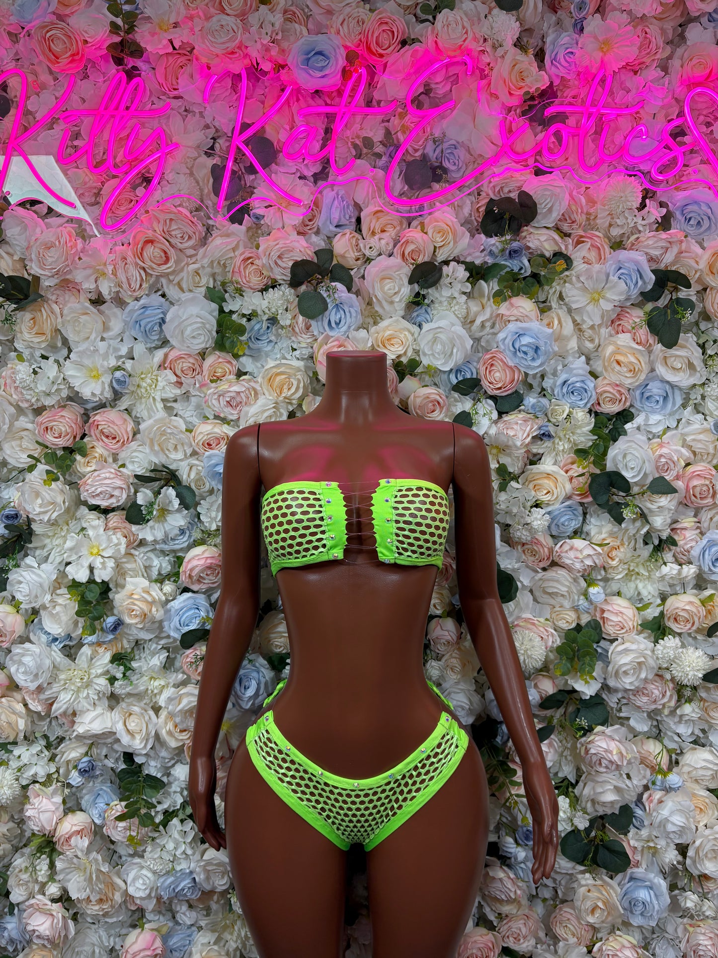 Neon green fishnet bikini set on mannequin, scoop neckline and high-cut bottoms