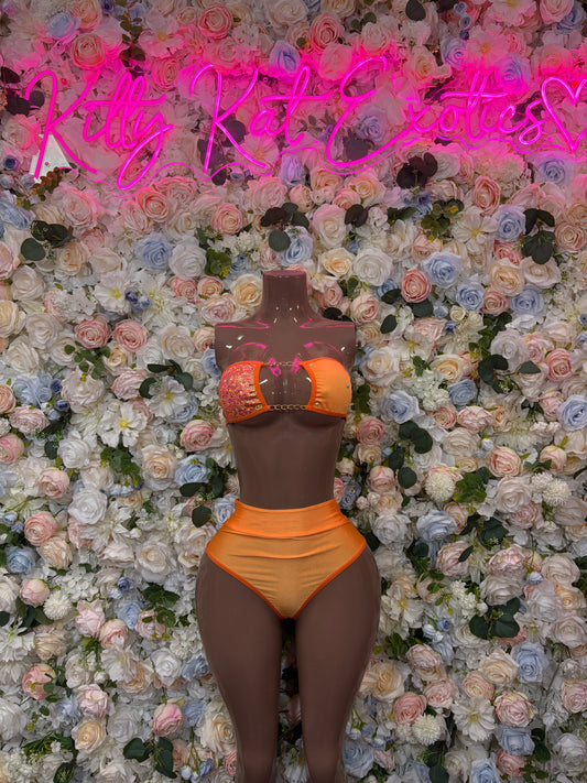 Orange two-piece bikini set on mannequin, halter-style top and high-cut briefs