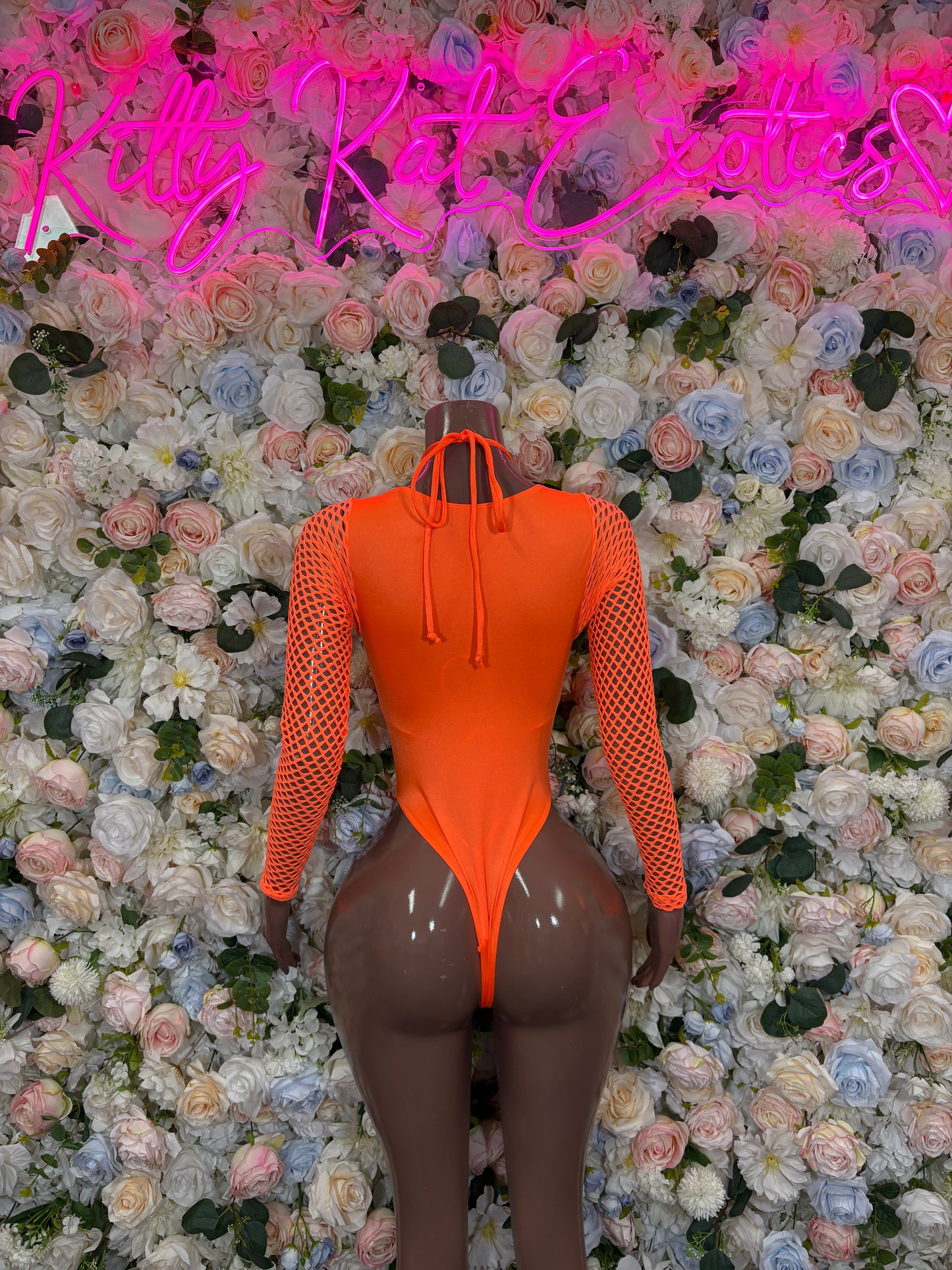 Orange one-piece bodysuit with long fishnet sleeves and deep V neckline
