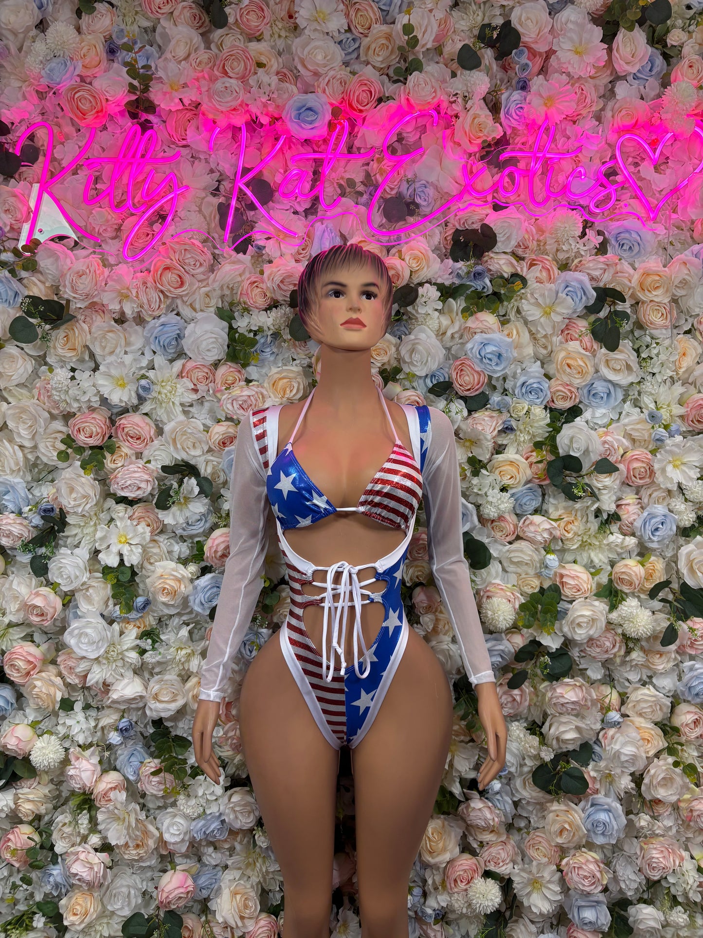 American flag bodysuit with lace-up front and long sheer sleeves, high-cut legs