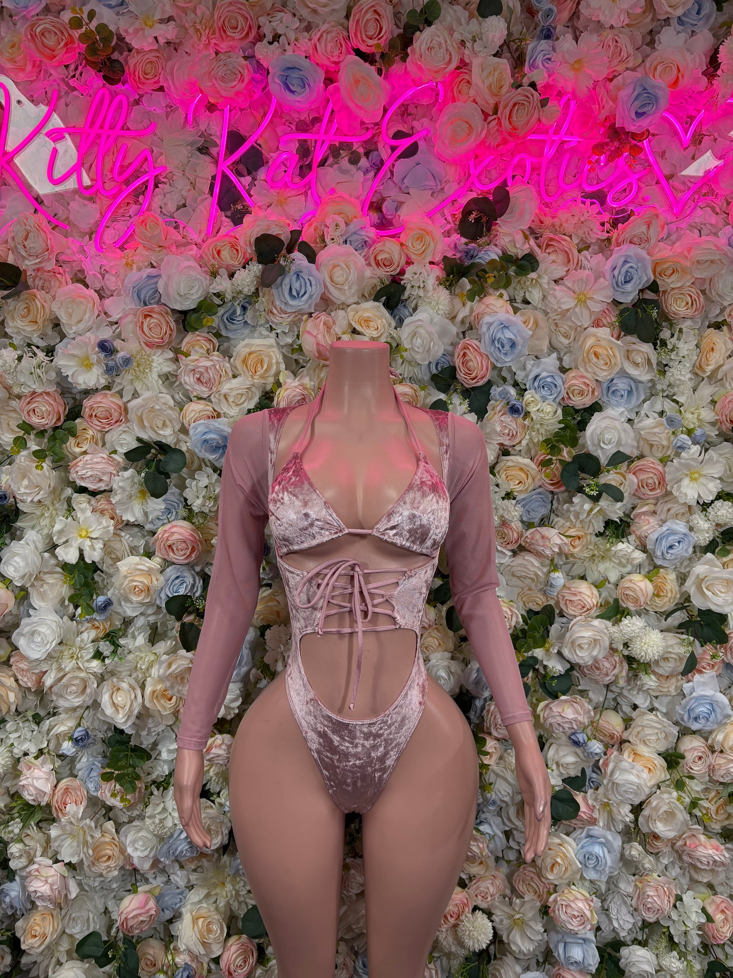 Rose pink velvet bodysuit with long sleeves, lace-up front and cheeky coverage