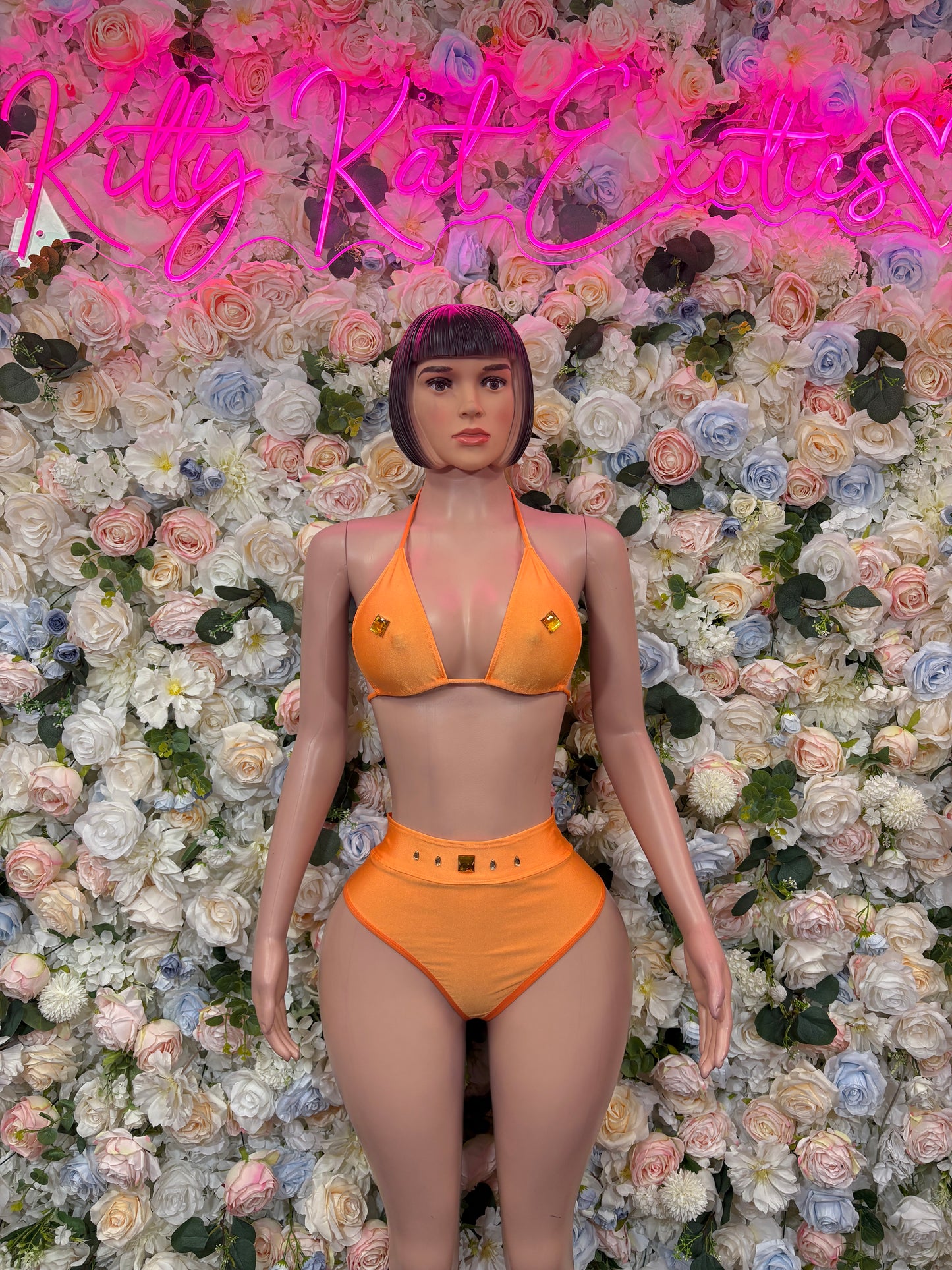 Orange two-piece dancewear set with triangle bikini top and matching high-waist bottoms