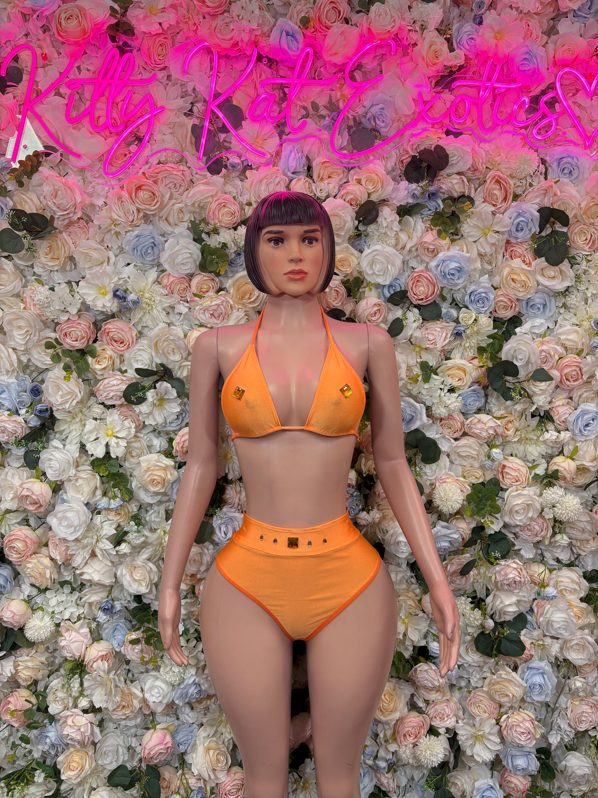 Orange two-piece dancewear set with triangle bikini top and matching high-waist bottoms