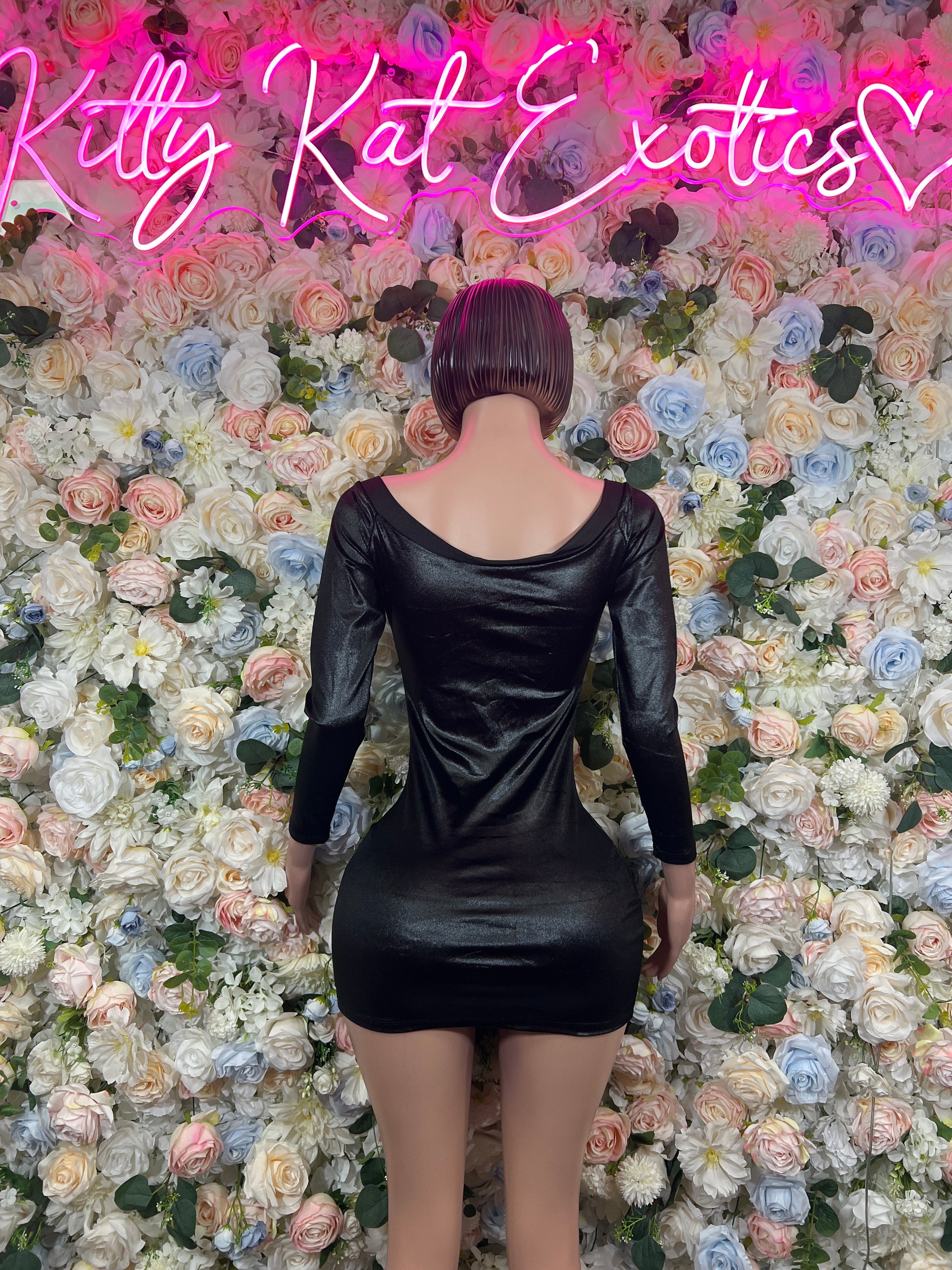 Black long-sleeve mini dress, fitted, deep scoop back