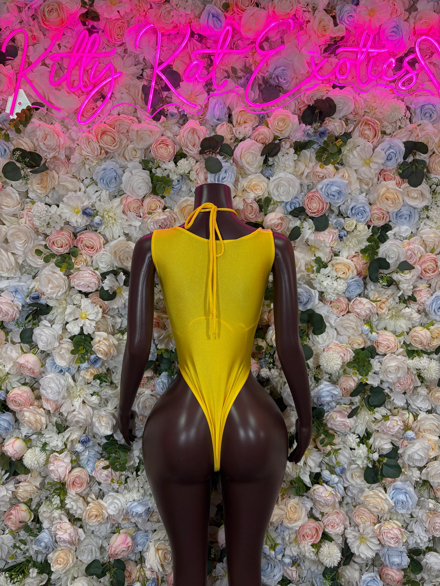 Yellow metallic sleeveless bodysuit with deep V front and high-cut legs