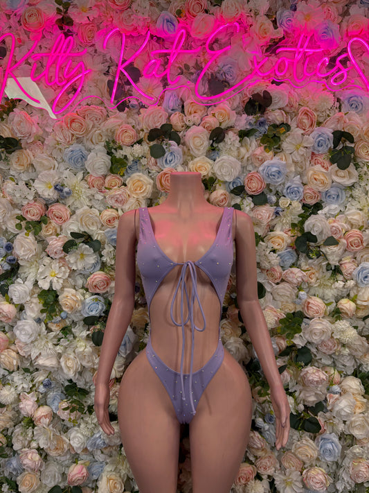 Lilac one-piece bodysuit with open back, halter straps, and lace-up tie back