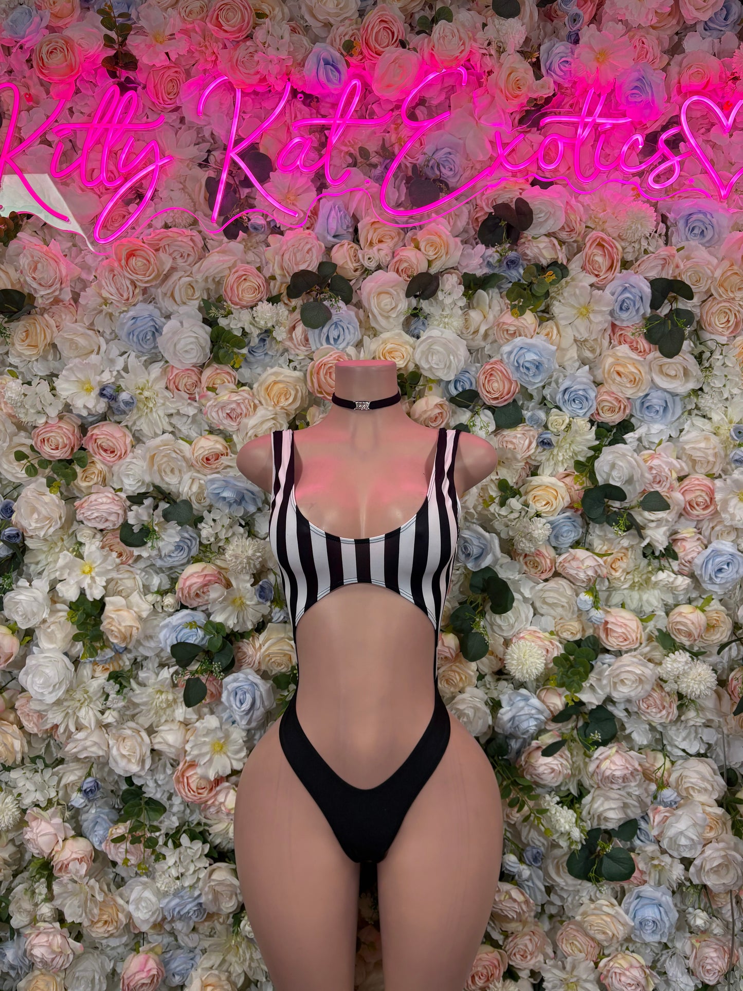 Striped one-piece bodysuit with black trim and high-leg cut