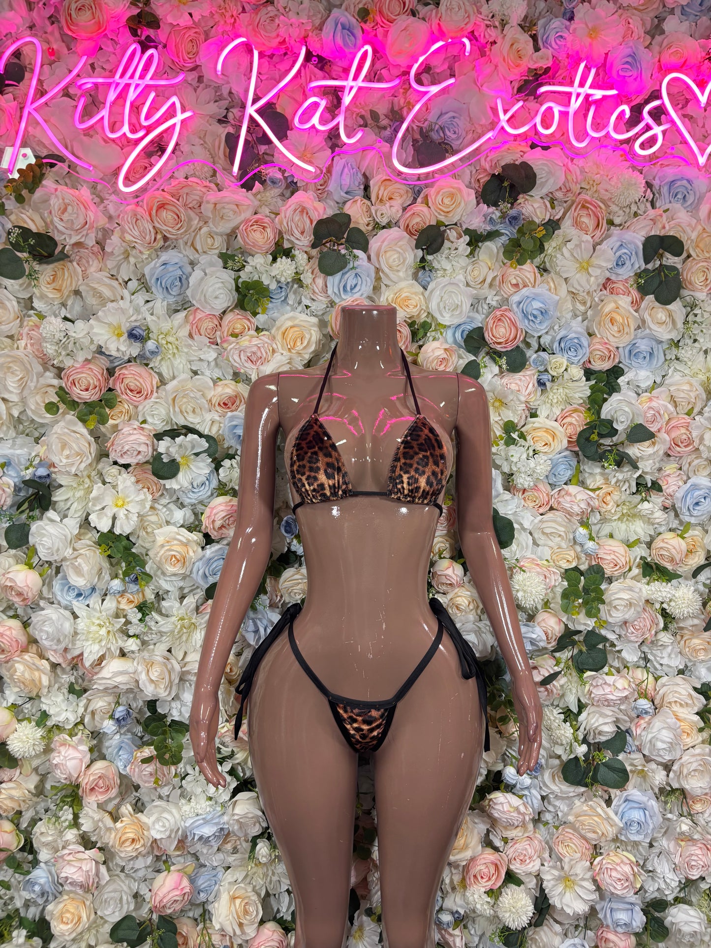 Leopard-print hologram-style bikini set with black straps on mannequin, front view