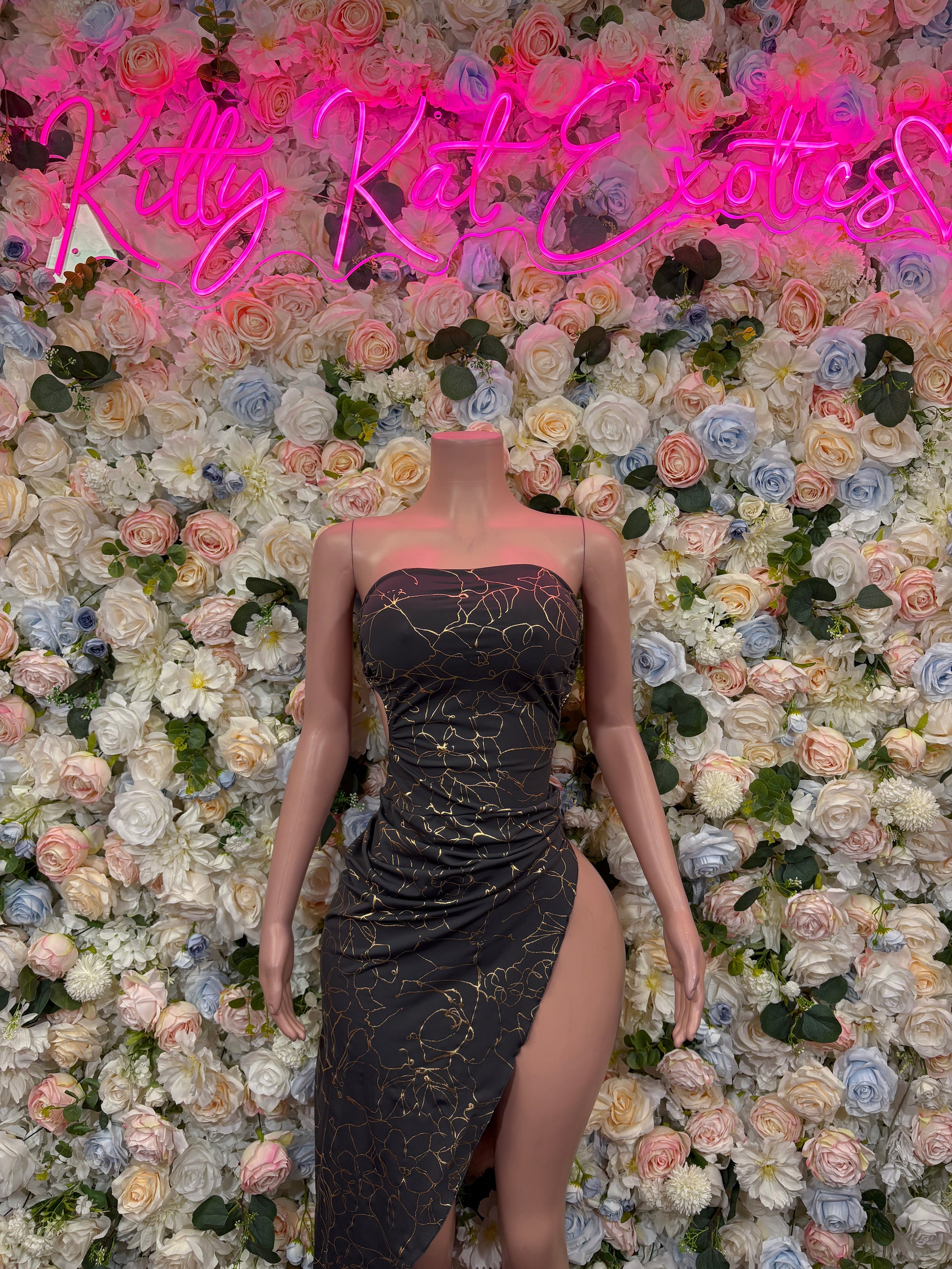 Black and gold strapless gown with patterned sheen and high side slit