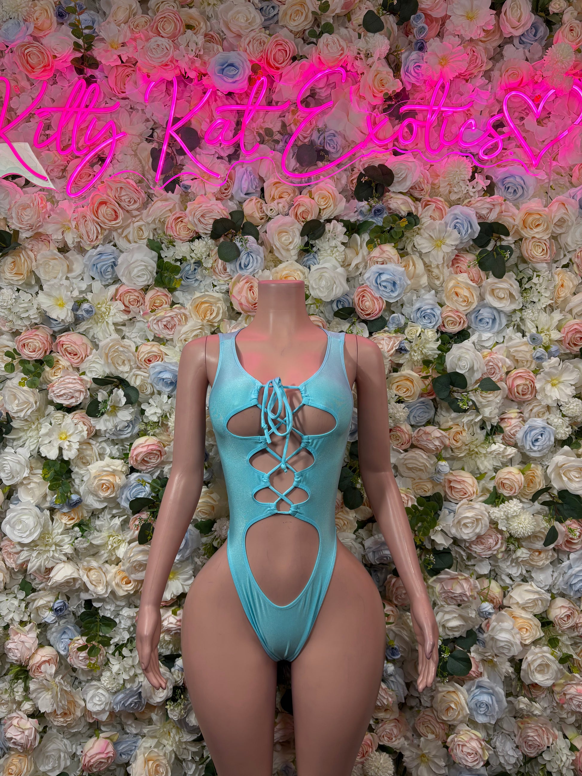Teal lace-up bodysuit with crisscross chest cutouts and high-leg coverage