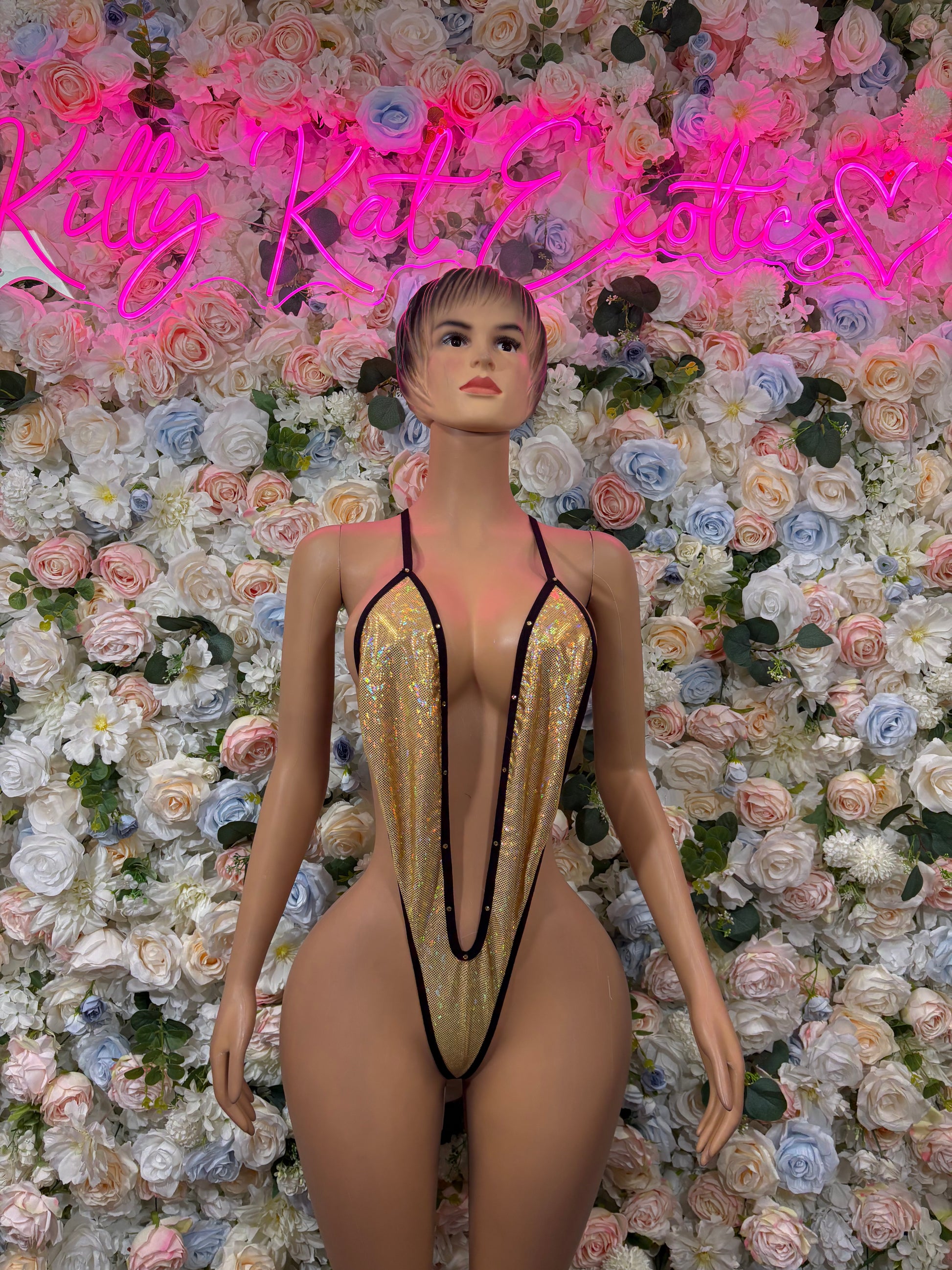 Gold sequin slingshot bodysuit with black spaghetti straps, front view.