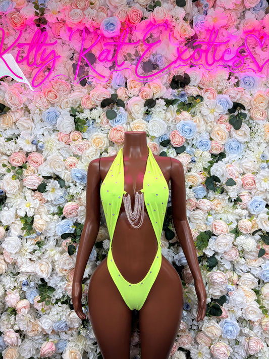 Neon green backless bodysuit with halter straps and silver chain drape