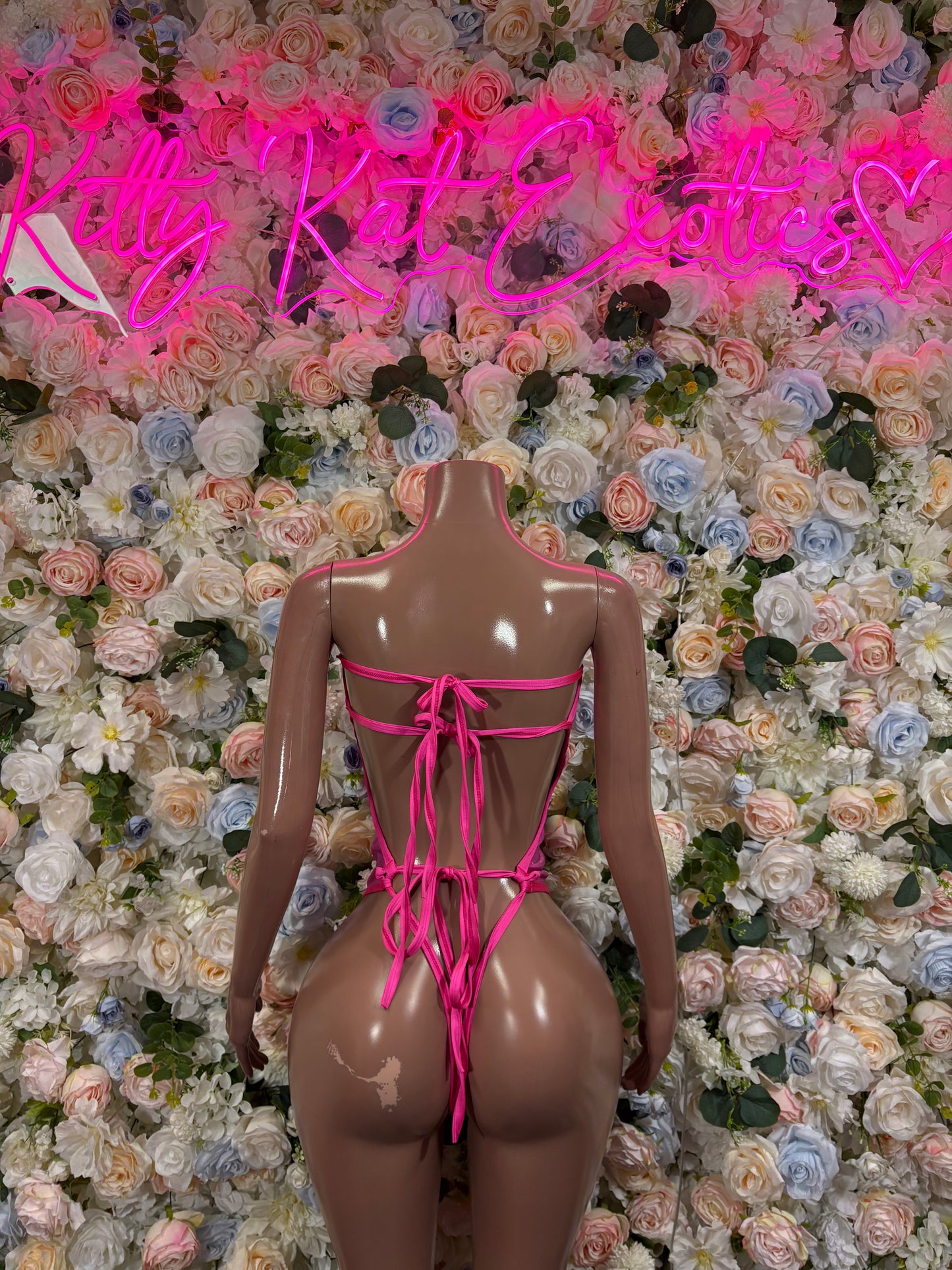 Metallic pink one-piece rave bodysuit with back lace-up ties and cheeky cut