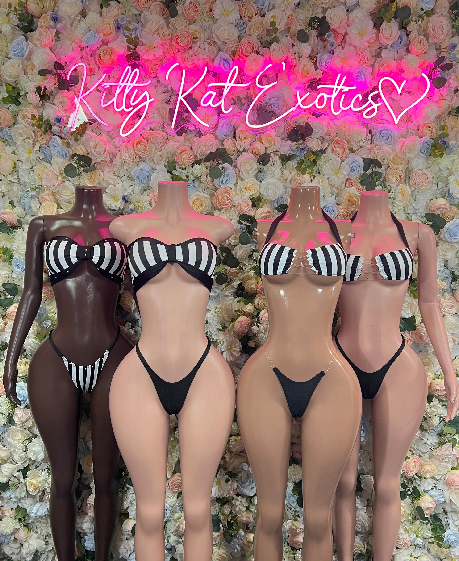 Black string bikini with white striped cups and thong bottoms on mannequins, front view