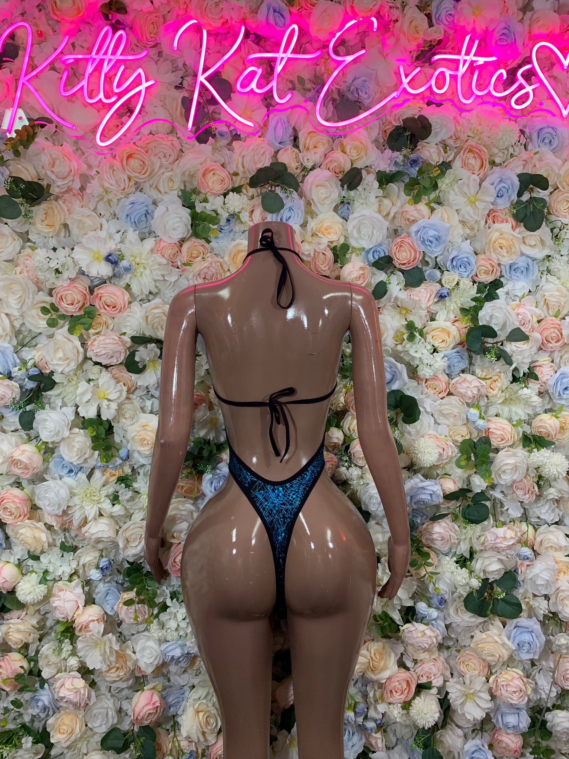 Blue metallic one-piece bodysuit with halter straps and high-cut front