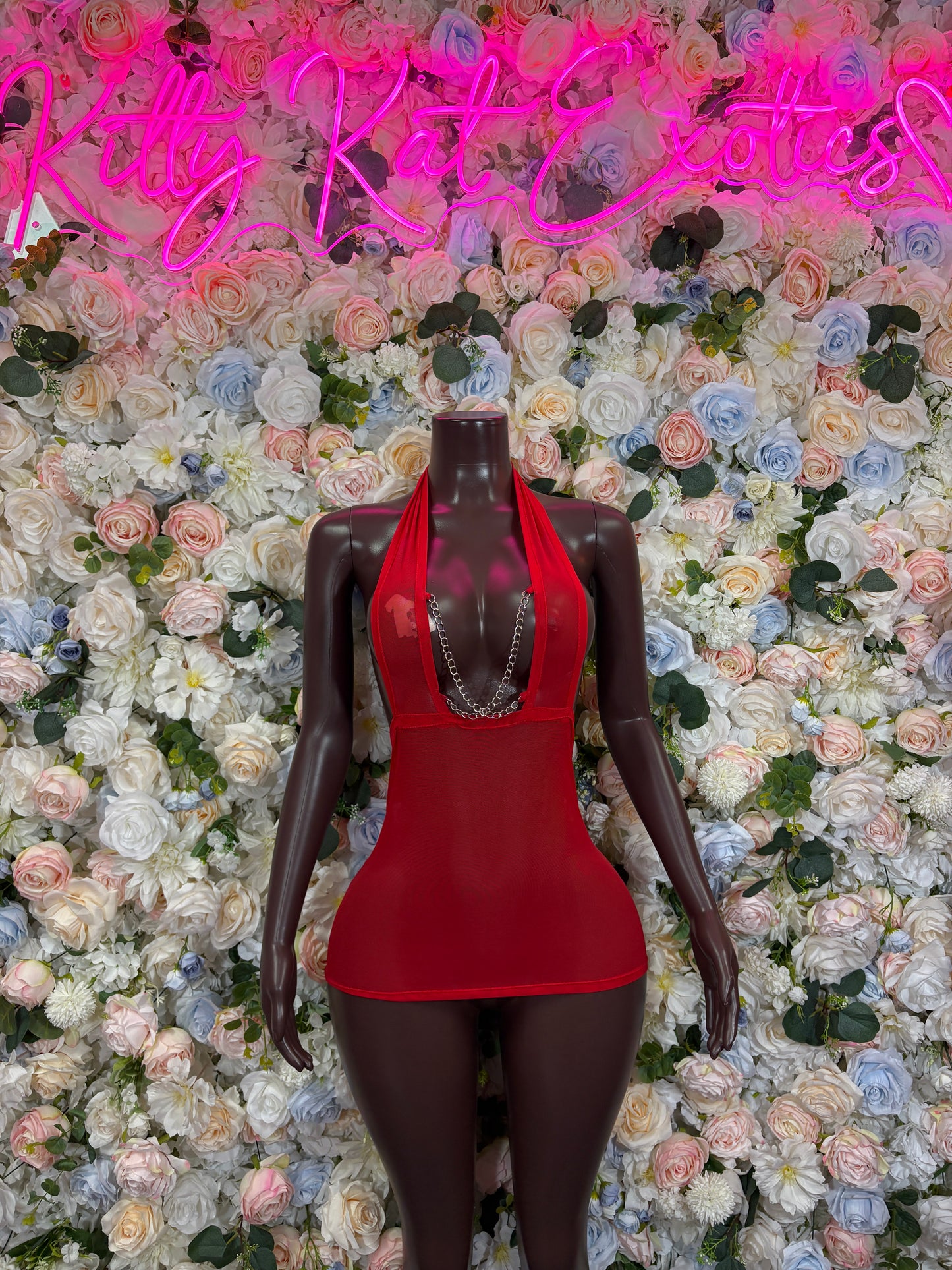 Red halter bodycon mini dress with V-neck cutout front detail.