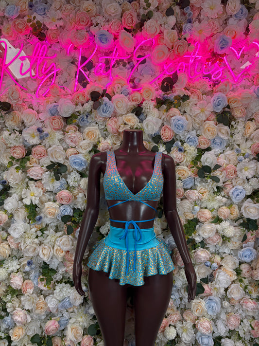 Teal glitter bra and ruffled mini skirt set on mannequin