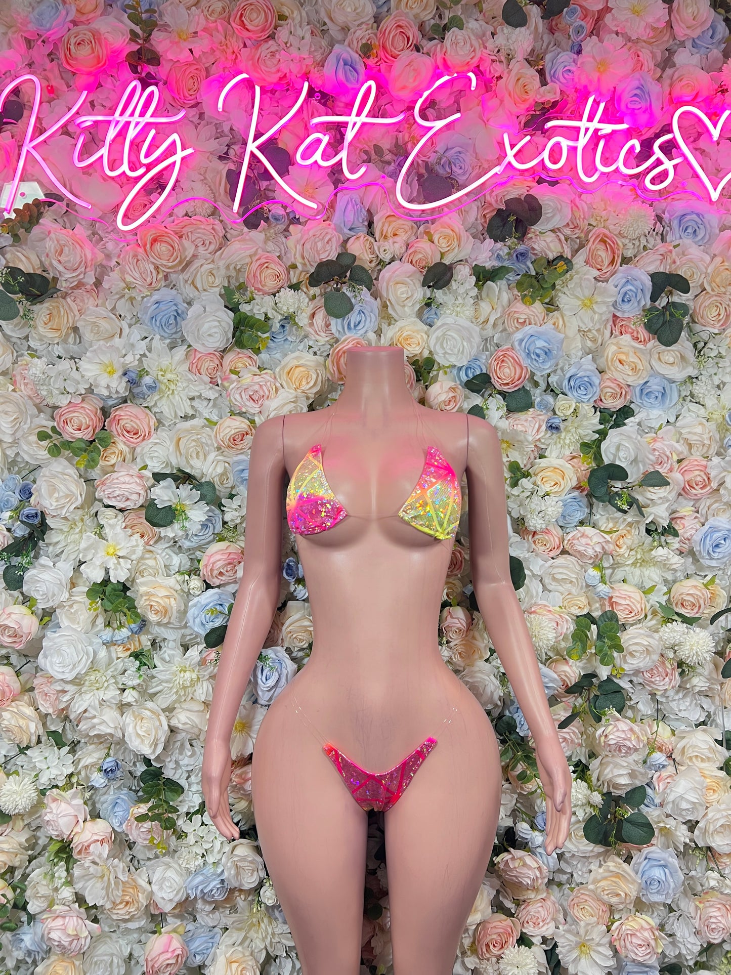 Pink triangle bikini with yellow print accents, front view on mannequin